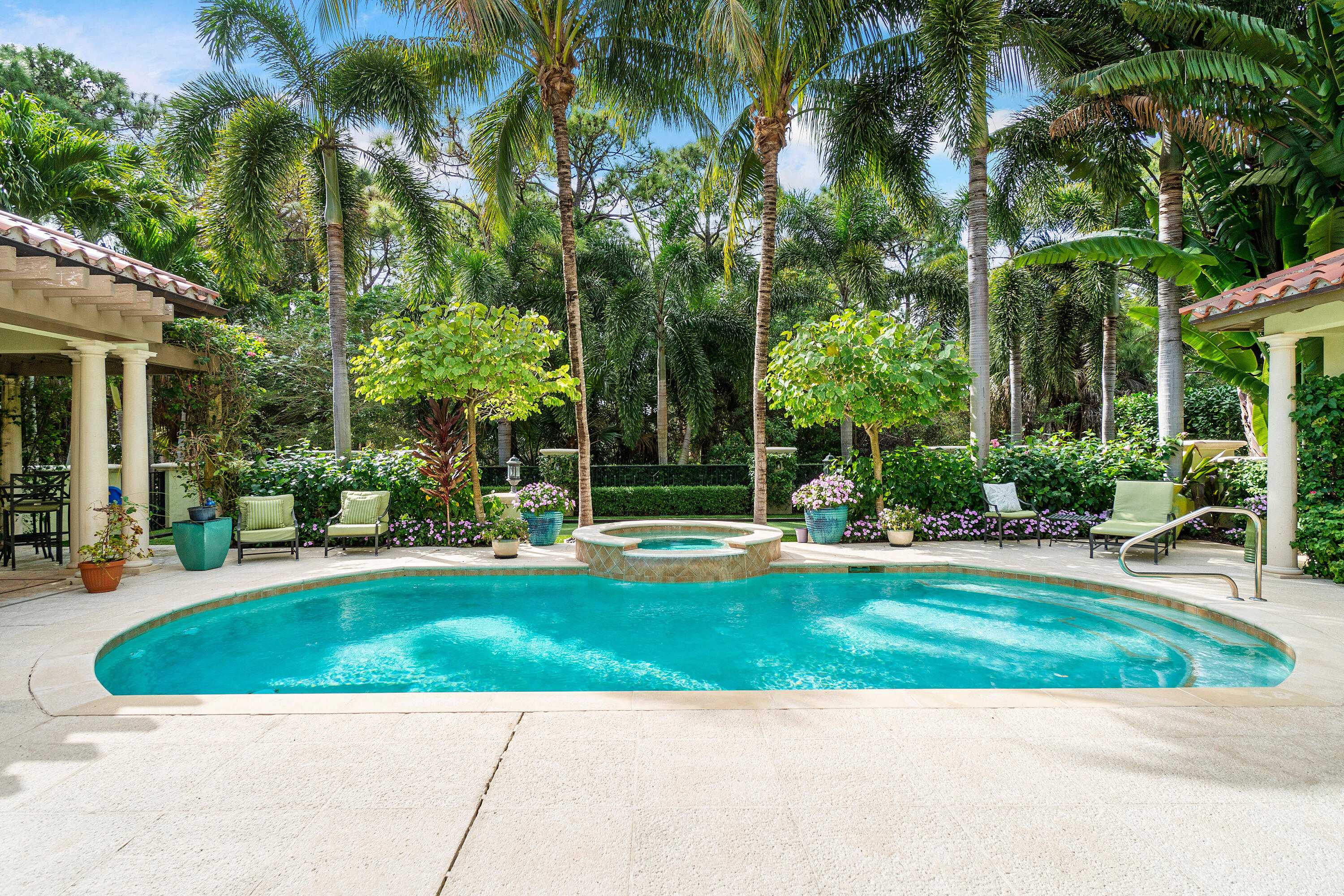 MEMBERSHIP OPTIONAL. This stunning Estate Home on the spectacular Jack Nicklaus Signature Golf Course at Trump National offers four spacious bedrooms, four full baths, plus two half baths, summer kitchen, screened sitting area, pool, lushly landscaped backyard and golf course views.
The beautiful foyer opens to a large living room with an inviting fireplace and French doors overlooking a relaxing screened porch sitting area, serene pool and picturesque golf course views. The backyard oasis also includes a putting green area/bocce ball court and outdoor half bath.
The oversized Master bedroom includes a sitting room, two generously sized closets, an extra-large master bath with soaking tub, large shower, and two separate marble topped vanities. The masterfully designed Chef's kitchen with detailed wood coffered ceilings, features top of the line appliances, stainless steel gas oven, enormous custom wood island with extra sink and plenty of seating for enjoying your morning coffee. The custom-built cabinets offer plenty of storage and a convenient desk area. The dining area and family room are conveniently located for entertaining, and there is also a large wine room with two wine storage coolers just off the kitchen. 
The upstairs guest area offers privacy and includes three generously sized ensuite bedrooms and a large entertaining/loft area.  
There is a two-car attached garage, as well as an additional detached one car garage.
Club Membership is optional.