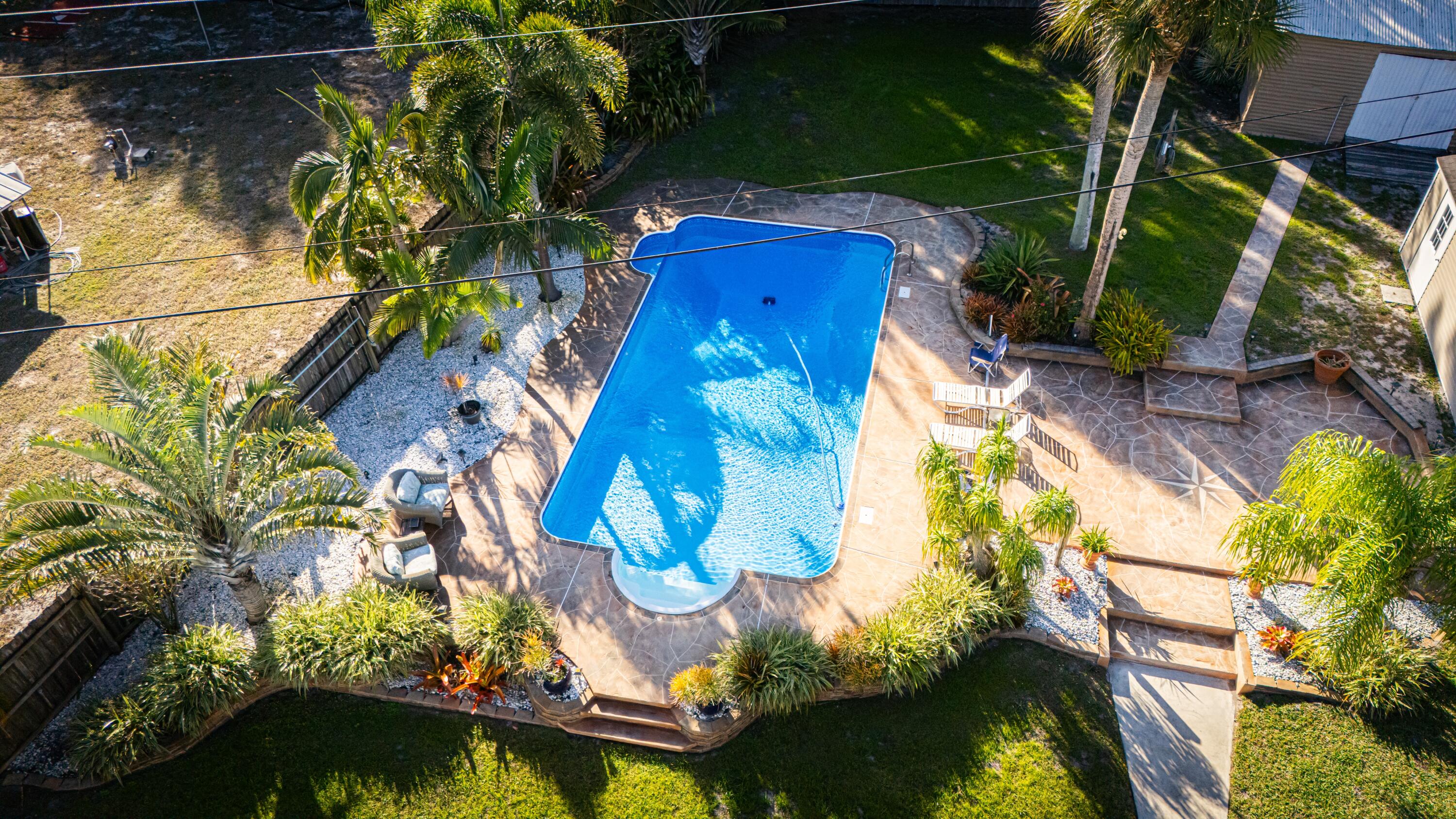 Experience the ultimate coastal lifestyle in this stunning waterfront pool home situated on nearly an acre along the prestigious and historic Indian River Drive. This meticulously renovated 3-bedroom, 2-bathroom residence offers over 2,400 square feet of bright, open living space featuring ceramic tile throughout, two cozy propane fireplaces, and expansive windows that frame breathtaking views of the Indian River Lagoon. The modern kitchen is a chef's dream with granite countertops, stainless steel appliances, and a beautiful outlook where you might even spot manatees or dolphins. Retreat to the spa-like primary suite, which now features dual vanities, a soaking tub, and a glass-enclosed shower, complemented by a massive 9x13 walk-in closet. Step outside to your private tropical oasis fea Experience the ultimate coastal lifestyle in this stunning waterfront pool home situated on nearly an acre along the prestigious and historic Indian River Drive. This meticulously renovated 3-bedroom, 2-bathroom residence offers over 2,400 square feet of bright, open living space featuring ceramic tile throughout, two cozy propane fireplaces, and expansive windows that frame breathtaking views of the Indian River Lagoon. The modern kitchen is a chef's dream with granite countertops, stainless steel appliances, and a beautiful outlook where you might even spot manatees or dolphins. Retreat to the spa-like primary suite, which now features dual vanities, a soaking tub, and a glass-enclosed shower, complemented by a massive 9x13 walk-in closet. Step outside to your private tropical oasis featuring a massive 18x40-foot pool with LED lighting and deck jets, a 12x32 veranda, and a private path leading to over 100 feet of direct water frontage with a large riverfront deck for fishing or enjoying the sunrise. Complete with a private well, Pelican water purification system, and two large outbuildings for extra storage, this rare find offers unmatched privacy and luxury less than five miles from vibrant downtown Fort Pierce.