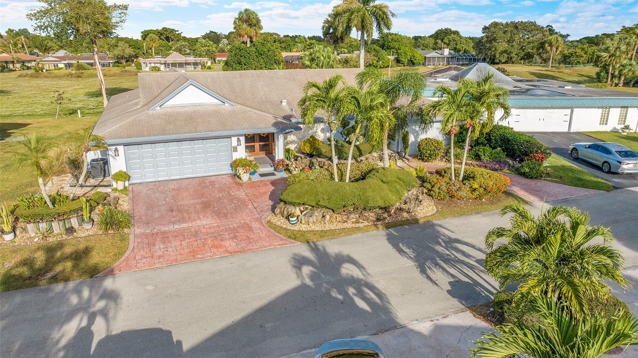 PRICE IMPROVEMENT - This pristine mid-century 3-bedroom, 2.5-bath home blends timeless style with modern luxury. Impact doors and windows ensure superior protection and excellent insurance rates, while natural light highlights the home’s refined craftsmanship.  The renovated chef’s kitchen features upgraded cabinetry and newer high-end appliances. The spa-inspired primary bath suite is beautifully updated and designed for total relaxation. Expansive windows frame rolling green hills, creating seamless indoor-outdoor living. Outside, enjoy a sparkling saltwater pool and upgraded patio, perfect for peaceful retreats or elegant entertaining. A rare blend of mid-century charm and modern luxury—this home is truly turnkey and unforgettable. Impact windows and doors; AC - 3 years old; Water Heater - 1 year old; Renovated kitchen; Renovated Master Bath; Saltwater Pool with all tubing replaced; Newer Kichen appliances; Washer 1 year old.