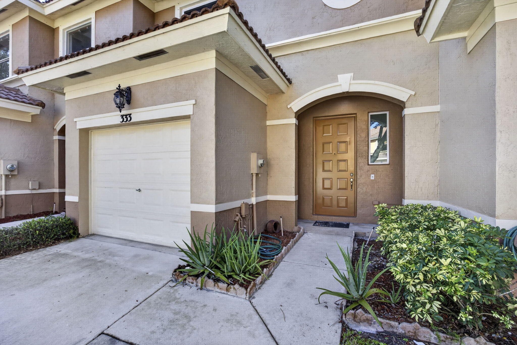 Welcome to this beautifully maintained townhome located in a gated, all-age, pet-friendly community! This 2-bedroom, 2.5-bath residence offers the perfect combination of comfort, privacy & convenience. The 1st floor features wood-look ceramic tile flooring & an updated kitchen designed for both everyday living & entertaining. Hurricane impact windows & sliding glass doors provide peace of mind, energy efficiency & abundant natural light throughout the home. Step outside to your screened patio with a water view & a tranquil park-like garden setting with no rear neighbors, creating a private outdoor retreat perfect for relaxing or enjoying your morning coffee. Upstairs, both spacious bedrooms feature walk-in closets and en-suite bathrooms, offering comfort & functionality! Additional updates include a new A/C (2026) and water heater (2018). Parking is a breeze with a one-car garage plus a driveway that accommodates two additional vehicles. Seminole Lakes boasts multiple swimming pools, basketball courts, kids playgrounds, walking trails & more! Ideally located within walking distance to Calypso Bay Waterpark, neighborhood parks with baseball fields, this home offers an exceptional lifestyle with recreation just steps away. Whether you're a first-time homebuyer, seasonal resident, or looking to downsize, this move-in-ready townhome is one you won't want to miss!