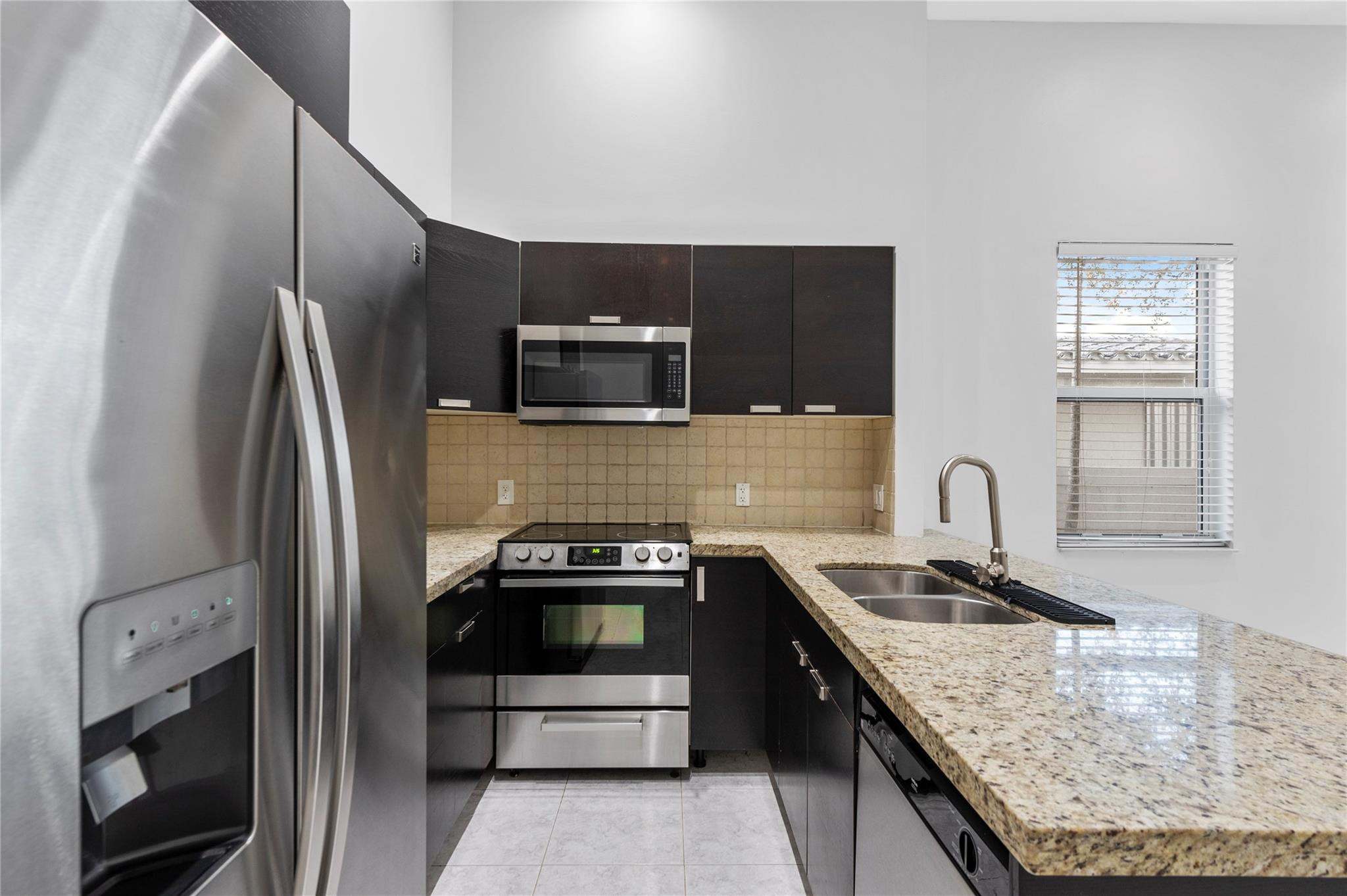 Discover modern living in this stunning Fort Lauderdale townhome, ideally situated near the vibrant downtown scene. This 3-bedroom, 2.5-bath (+den/office) property boasts sleek finishes, an open-concept layout, and abundant natural light. The spacious kitchen features high-end appliances and a breakfast bar, perfect for entertaining. Relax on your private patio or take a short stroll to nearby hotspots. Enjoy easy access to Las Olas Boulevard's trendy restaurants, boutique shops, and art galleries, or explore the scenic Riverwalk. Just minutes from Fort Lauderdale Beach and major transportation hubs, this home offers a perfect blend of convenience and urban charm. Full size washer/dryer inside the townhome. Private, fenced in spacious backyard. 1 car garage! NO HOA - MOVE IN TOMORROW!