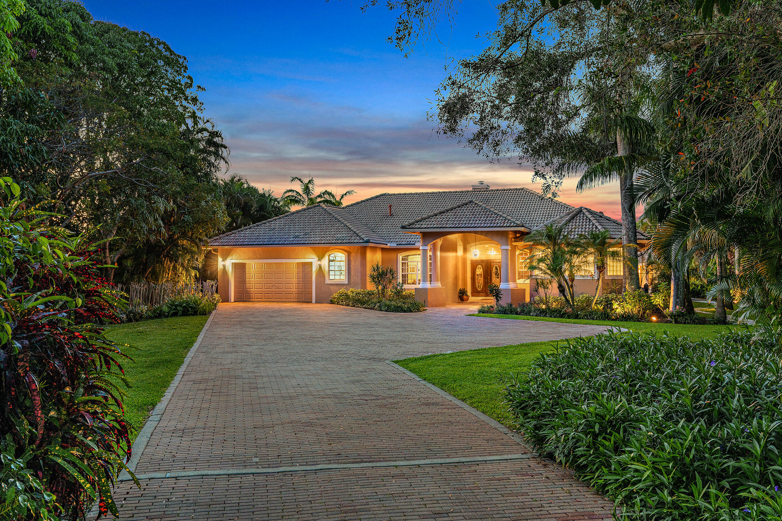 Extremely rare opportunity to own a 1.6 acre Riverfront parcel/home on the beautiful and scenic Loxahatchee River.  This 4BR/4Bth pool home was built in 1999 and sits on a huge lot with wonderful, serene river views, lush tropical landscaping and privacy galore!  A few interior features of this clean, well keep home include custom ceilings, formal living room with dual-sided fireplace, open kitchen with prep island overlooking the large family room, game room with wet-bar and spacious master suite with sitting area.  Exterior features include a pool w/ spa, cabana with bathroom & boat storage, basketball court, a fully equipped dock with 2 lifts & BOAT HOUSE (Extremely rare on the Lox. River and is grandfathered in) and over 100' of direct river frontage.