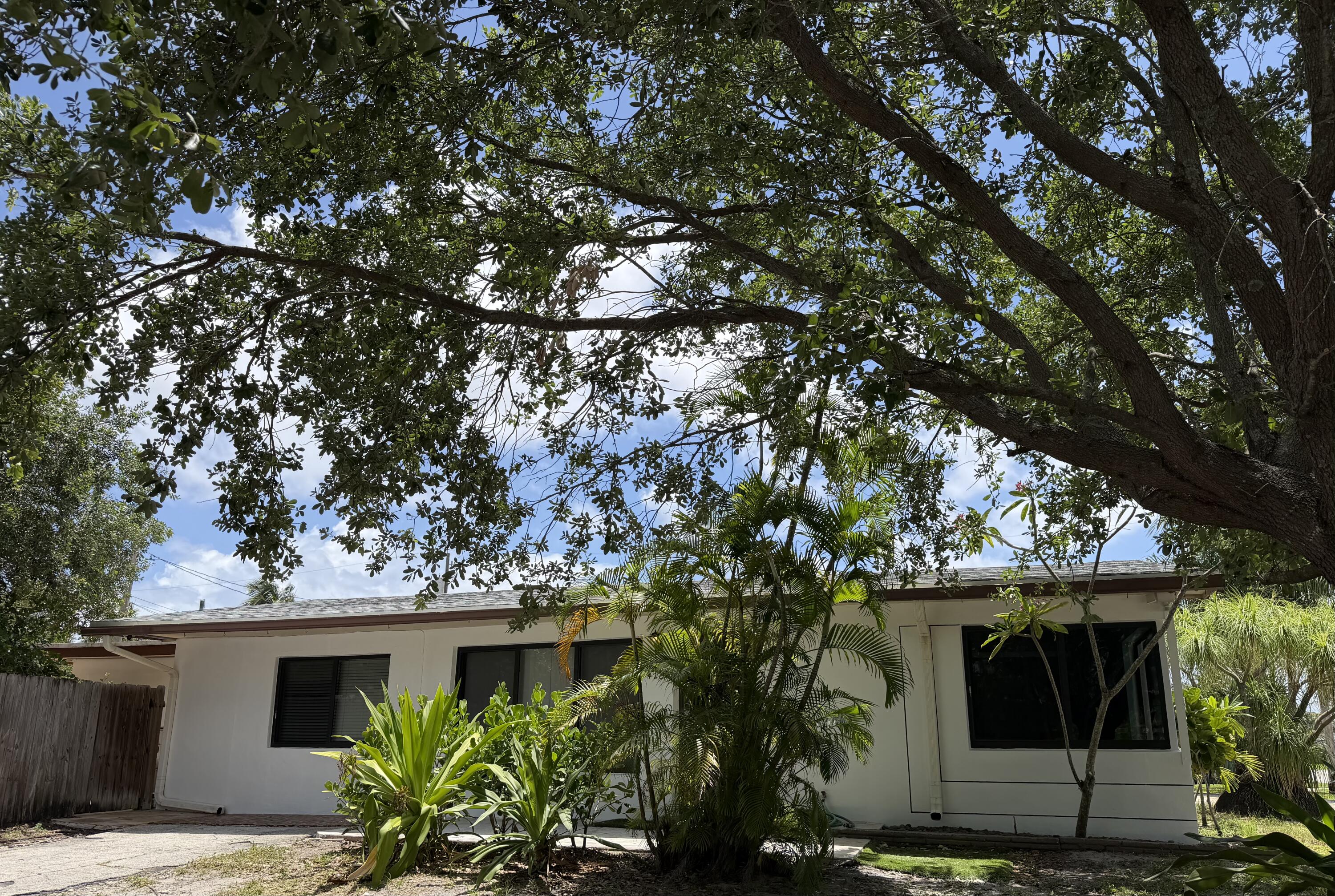 Spacious 3/2 on a corner lot with huge paved yard.   Fabulous for cookouts or any activity plus a  Double gate gives access to park  a Trailer, boat, or cars etc in.  This home has almost all impact windows.   Nice white kitchen!  Formal dining room, and good size living room .   Full size washer /Dryer.  Fabulous location, close to parks, major highways, shopping, worship, etc... AC motor replaced in 2024.  Roof about 6 yrs old.     Plumbing replaced except for 6 ft in back of home..No HOA , easy to show!