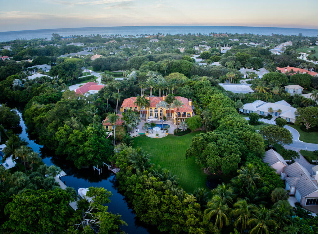 One of South Florida's most exclusive gated, the world renowned golf community of Seminole Landing. A Rare find, one of the few estate homes with a private gate in Seminole Landing, the hidden gem of North Palm Beach. No detail overlooked with extraordinary millwork throughout. Impact glass, whole house generator, guest cottage, dock situated on 2 acres. This exquisite custom home has direct access to Little Lake Worth and will not disappoint. Every inch of the property is covered with fountains throughout the gardens and all just a short walk to the private beach only Seminole Landing has to offer. Privacy, ocean and intracoastal water access. Seller is motivated bring offers.