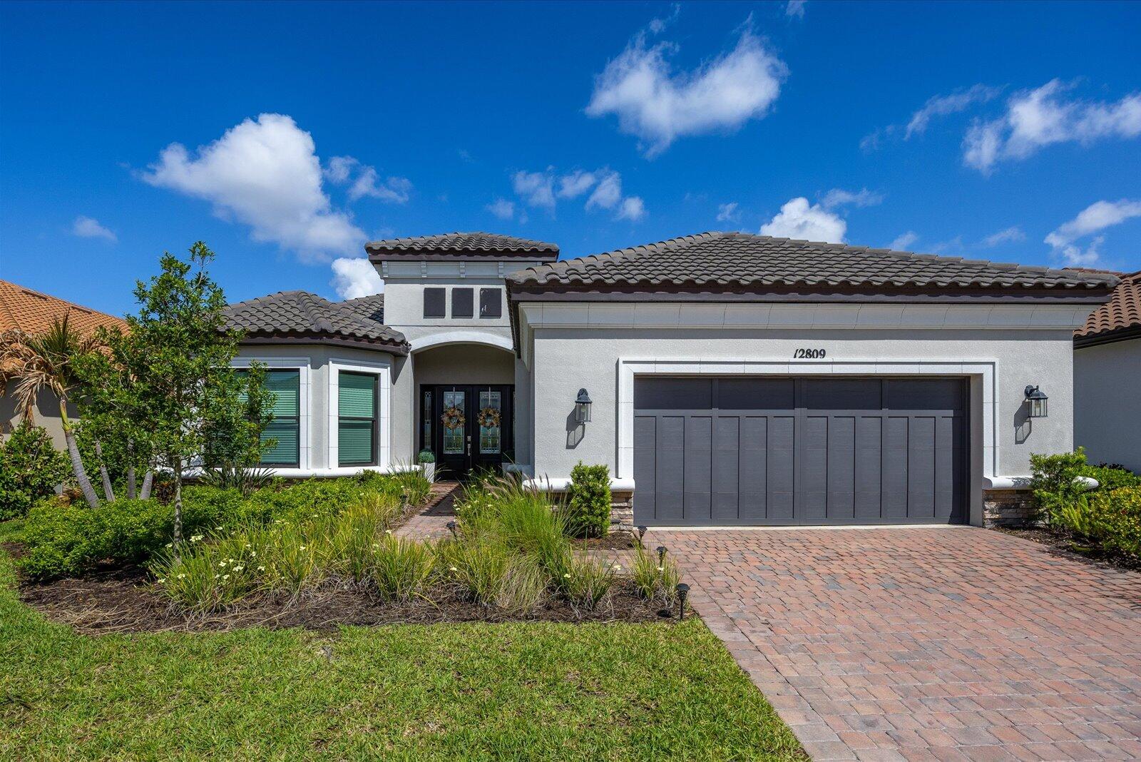 Welcome to your dream oasis at 12809 SW Barelli Ct in Port Saint Lucie! Located in Esplanade 55+ gated community. This stunning home features an upgraded kitchen with premium gas appliances and a farm sink, perfect for any culinary enthusiast. Enjoy peace of mind with impact windows and doors throughout, ensuring safety and energy efficiency. Step outside to your private pool and covered patio, ideal for relaxing or entertaining, complete with a custom outdoor grill setup. Revel in breathtaking views of the serene lake, creating a picturesque backdrop for your outdoor gatherings. With a brand new roof (2023), this home exudes elegance and modernity. Experience luxury living in a peaceful setting, all while conveniently located near amenities. Don't miss this extraordinary opportunity!