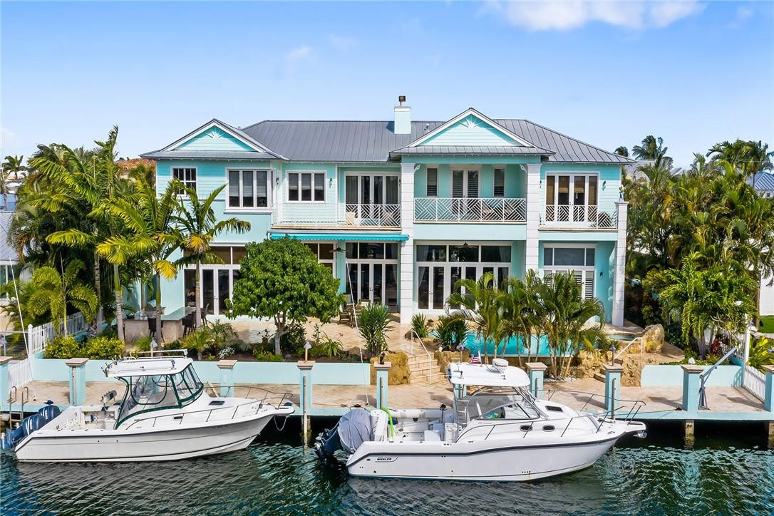 This 8,084 square foot coastal style home is less than one mile from the Hillsboro Inlet. This amazing 5 bedroom 6.5 bath home features top of the line chef's kitchen, bamboo wood floors, full house generator with automatic transfer switch, coral and cypress details throughout and a Pirates' of the Caribbean themed movie theater. Spacious master suite with beautiful water views featuring full his and hers bathrooms and large his and hers closets. Out back is a large tropical patio with summer kitchen, sparking pool with infinity edge and jacuzzi all with a desirable southern exposure. Concrete 100 foot dock with power and water for large boats and just minutes to the inlet this is the ideal location for boaters and fisherman a like.