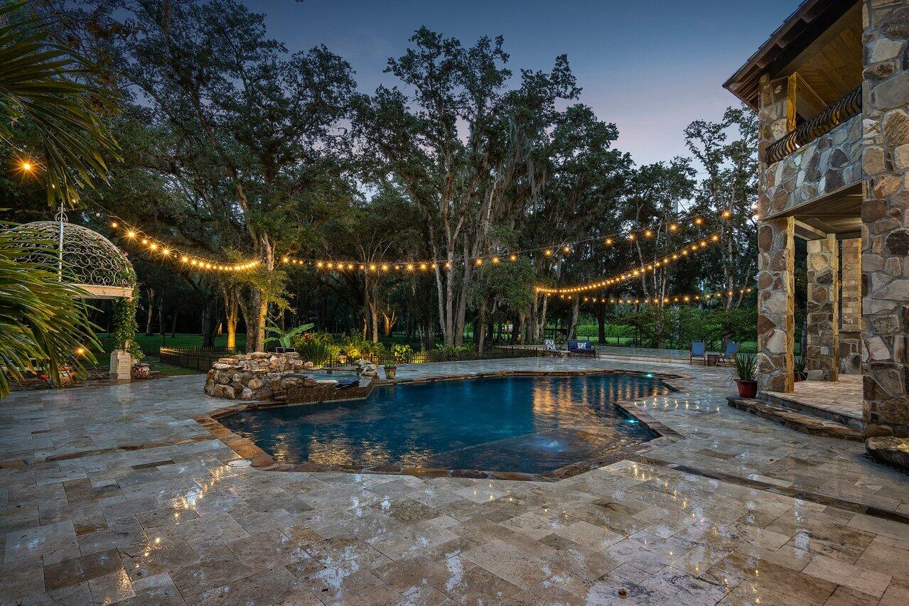 Back on the market and major price reduction. Welcome home to your pristine country estate in St Lucie County with 5 bedrooms, 3.5 bathrooms, 4 car garage and 20 acres of privacy to disconnect, entertaining friends, or enjoy some of natural Florida. Incredible attention to detail on this custom built estate. Property is sold furnished. Impact windows throughout, gas powered appliances including stove, dryers, pool heater, bbq grill, and both fireplaces. Property has four horse stall, irrigation pond, koi pond, partial electric perimeter fence, security camera system, extensive landscape lighting, secure gate with call box, dozens of native Florida trees, and so much more.