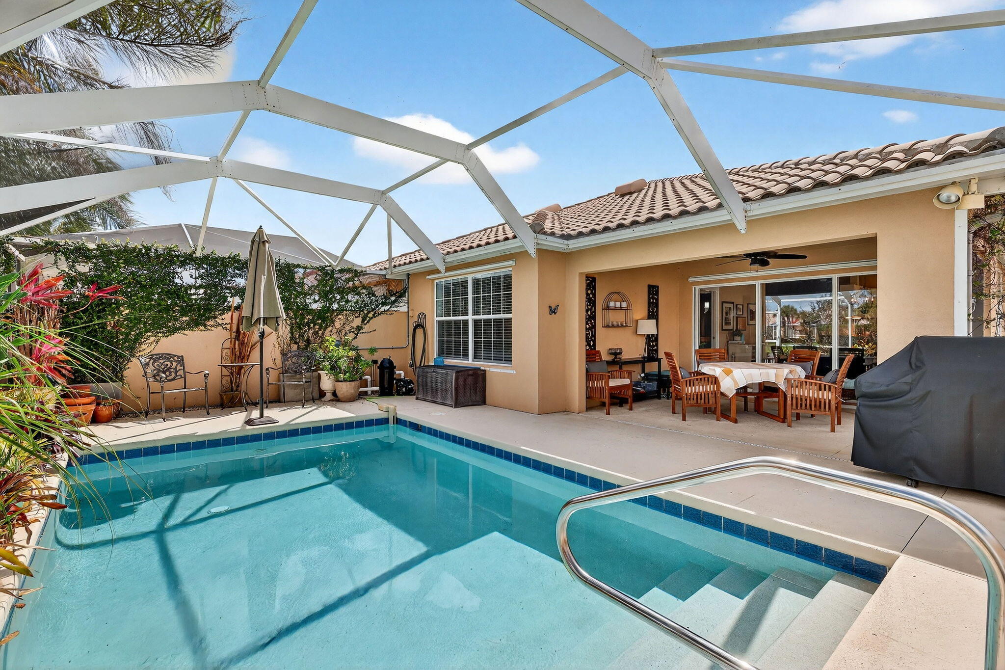 Most villas in this community are nice. This one is different — every major system has been updated, the décor is move-in ready, and all you have to do is unpack.  With over $30,000 in recent upgrades, this immaculate villa has been meticulously prepared for its next owner. A brand-new air conditioner (2026) — the single most important system in a Florida home — means you won't face that dreaded first-summer replacement. The updated water heater (2020), new bedroom carpeting, modernized kitchen with stainless steel appliances, clever drawer pull-outs and added storage, updated lighting and ceiling fans, and a striking glass entry door mean there is simply nothing left to do.  As a final touch, the HOA is scheduled to paint the exterior a fresh neutral color at no cost to you. And then there's the reward for making such a smart, worry-free choice: step out back and find a sun-drenched, heated screened pool bathed in glorious Florida sunshine all day long, overlooking a peaceful lake. With a newer pool heater and pump (2022), the water is always perfect — whether it's a cool January morning or a hot July afternoon. This is the outdoor Florida lifestyle you moved here for, delivered every single day. All of this sits within an exclusive 24-hour manned gated community with resort-style amenities: two heated pools, tennis, pickleball, basketball, bocce, a fully equipped fitness center, a vibrant clubhouse, and a playground. The HOA covers cable, internet, alarm monitoring, lawn care, and exterior painting — so your time is spent living, not maintaining. Built with solid poured concrete walls and finished with a handsome paver brick driveway and walkway, this home is as solid as it is beautiful. Available turn-key (excluding personal items) — this is the one you tour and make an offer on the same day. In a neighborhood full of options, this villa stands alone. Don't let someone else make that call first.