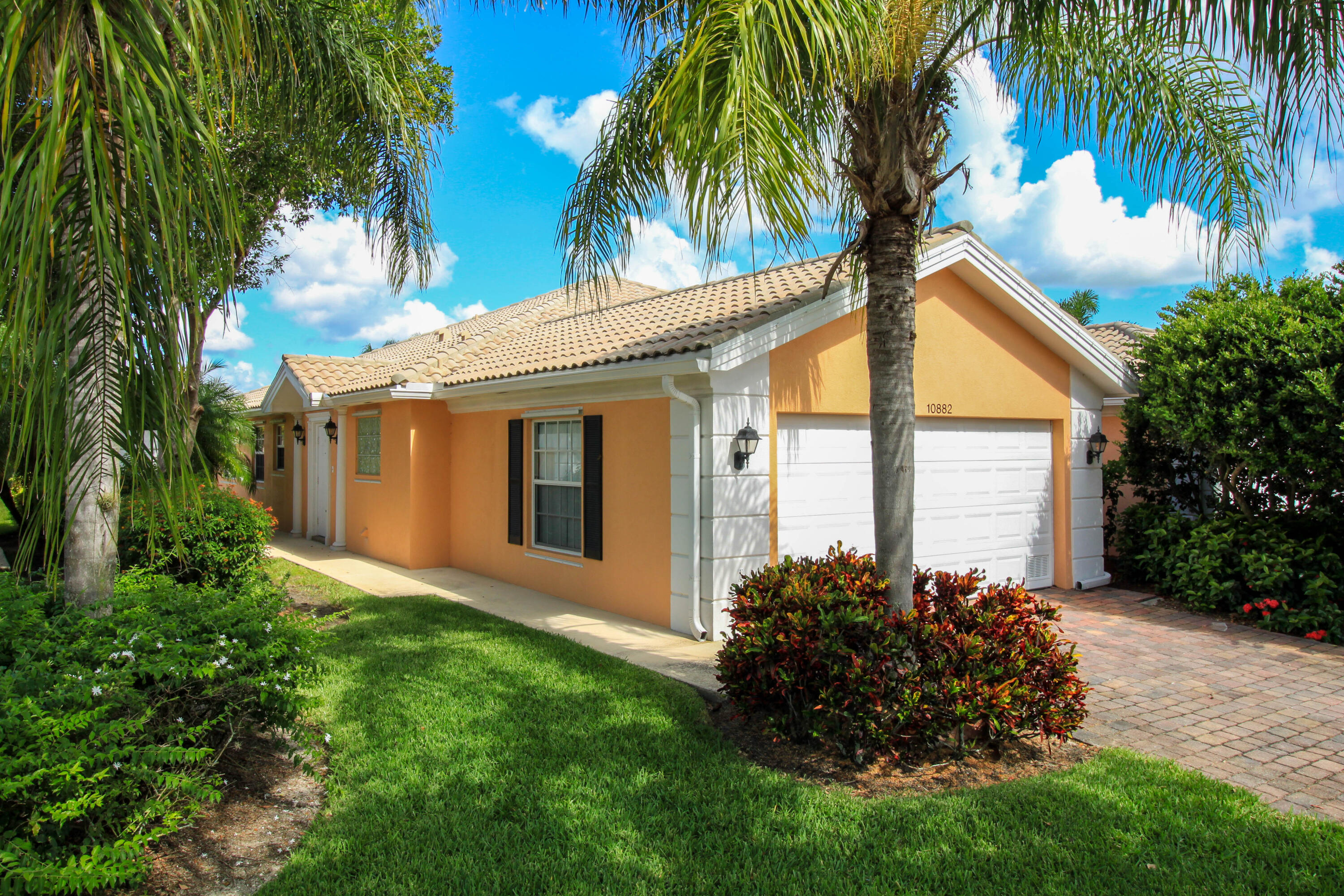 Beautiful Capri model in The Lakes at Tradition. Immaculate 2-bedroom, 2-bath home featuring a private screened lanai overlooking a beautiful preserve. Built with poured concrete construction and barrel tile roofs, this well-maintained home offers an open floor plan with two spacious primary suites in a split-bedroom layout, huge closets, and abundant storage. The kitchen features quartz countertops, a breakfast bar, and a dining area, while additional upgrades include a full-size washer and dryer, hurricane shutters, central vacuum system, and a 2-car garage with a workshop area. The exterior has been freshly painted. HOA includes basic cable, high-speed internet, security alarm monitoring, and lawn care for added convenience. Enjoy resort-style living in the highly desirable gated community of The Lakes at Tradition, with access to exceptional amenities including a clubhouse, fitness center, resort-style pool, pickleball and tennis courts, and a full calendar of social activities. Ideally located in the heart of Tradition, just a short walk to Publix, restaurants, shopping, and more.