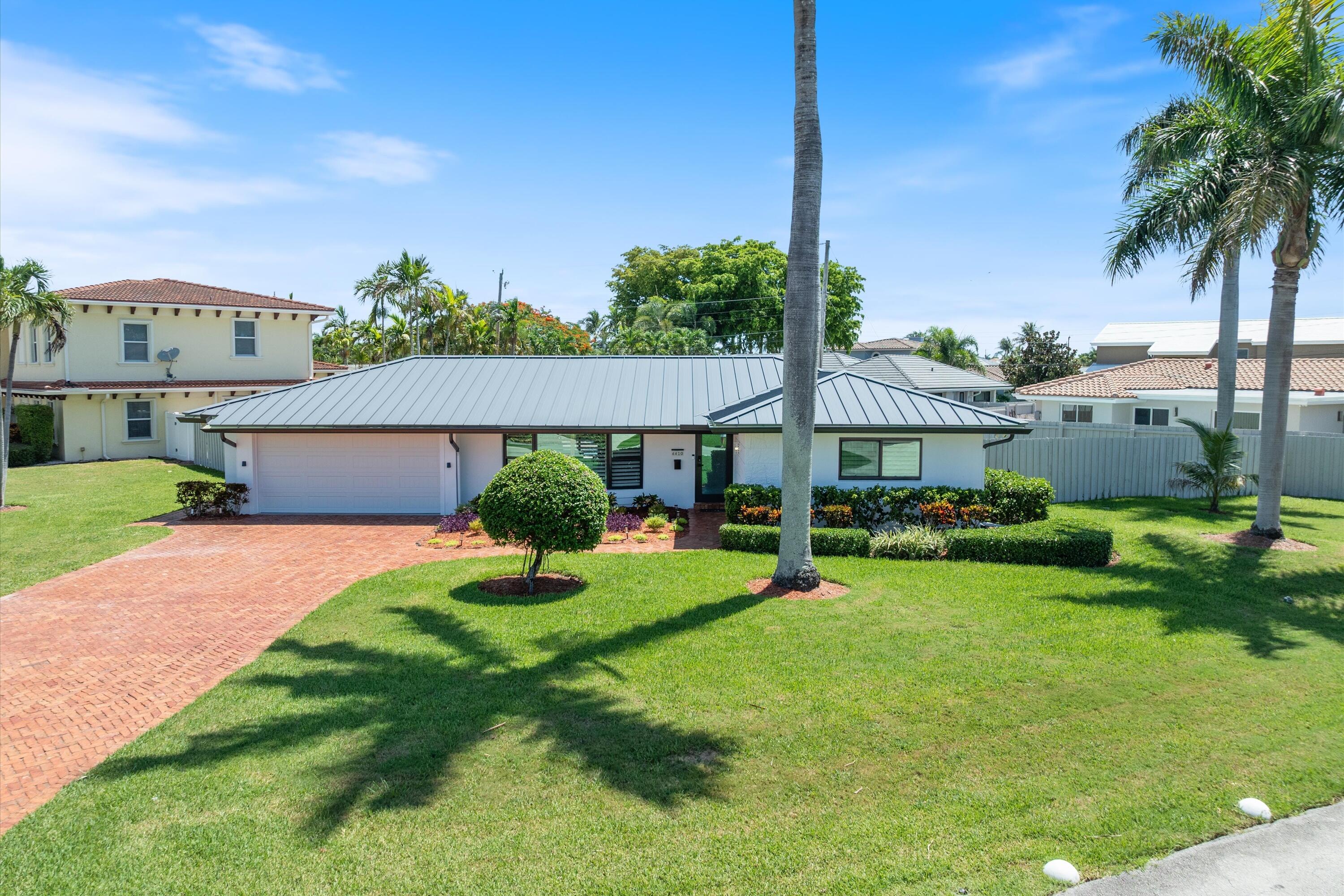Welcome to your own private resort in the heart of Lighthouse Point! Set on one of the largest lot on the street, this beautifully updated home offers move-in-ready peace of mind and true backyard luxury. Inside: fresh paint, new luxury vinyl plank flooring, a bonus flex room with hidden door, and a brand-new oven and cooktop. Major systems freshly replaced: new metal roof, new impact windows and doors throughout, new water heater, and new AC — exceptional peace of mind and storm protection for years to come. Out back, brand-new pavers surround a stunning zero-entry pool that eases into the water like a beach. The oversized lot makes this backyard perfect for hosting. Minutes from Lighthouse Point Yacht Club, PORT32 Marina, and top waterfront dining. Schedule your private tour today.
