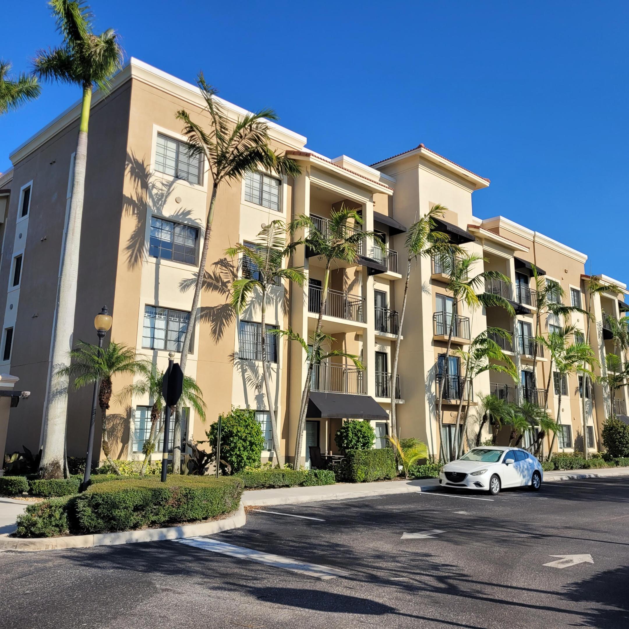 Welcome to luxurious Residences at Midtown - expect to be impressed with this updated move 2nd-floor corner unit, NEWLY PAINTED. The largest floor plan in the complex 1880 sqft with 1 COVERED ASSIGNED PARKING, private gated entry & ample guest parking. This exquisite 3-BR, 3-BA + DEN residence is move-in ready and offers a bright, spacious layout with multiple balconies overlooking the serene lake. Beautifully upgraded featuring a designer kitchen & baths with shaker-style cabinetry, exotic granite countertops, hardwood floors, crown molding and impact windows/doors. All bedrooms offer walk-in closets with custom built-ins. Double primary suite including dual sink vanities, soaking tub, private balcony access. A perfect blend of luxury, space and location in the heart of Palm Beach Gardens Facilities: Gated, secured community featuring a resort-style heated pool and spa, state-of-the-art fitness center, tennis courts, and media/business rooms. Neighborhood: Walkable access to Main Street at Midtown, Fresh Market, and various dining and shopping venues. Accessibility: Quick access to I-95 and the Florida Turnpike. It is just a 15 to 20-minute drive to Palm Beach International Airport and beautiful local beaches. 1 ASSIGNED COVERED PARKING SPACE (#13) Gated community with secured buildings, clubhouse, fitness rooms, large lap pool and hot tub. Walk right out of the community to Main Street at Midtown with shopping, dining and Fresh Market all just steps away. Easy access to I-95 and the Turnpike as well as schools, Downtown at the Gardens and The Gardens Mall and approximately 10-15 minutes to the beaches. The Residences at Midtown is an exquisitely maintained Gated Community with Lush Tropical Landscaping throughout the Community included within the Courtyard Areas and Gated Entryways. Featuring Sidewalks and Ample lighting throughout, a Resort Style Heated Pool & Spa, a state of the art Fitness Center, Business Center, Media Room, Tennis Court and on-site Property Management.