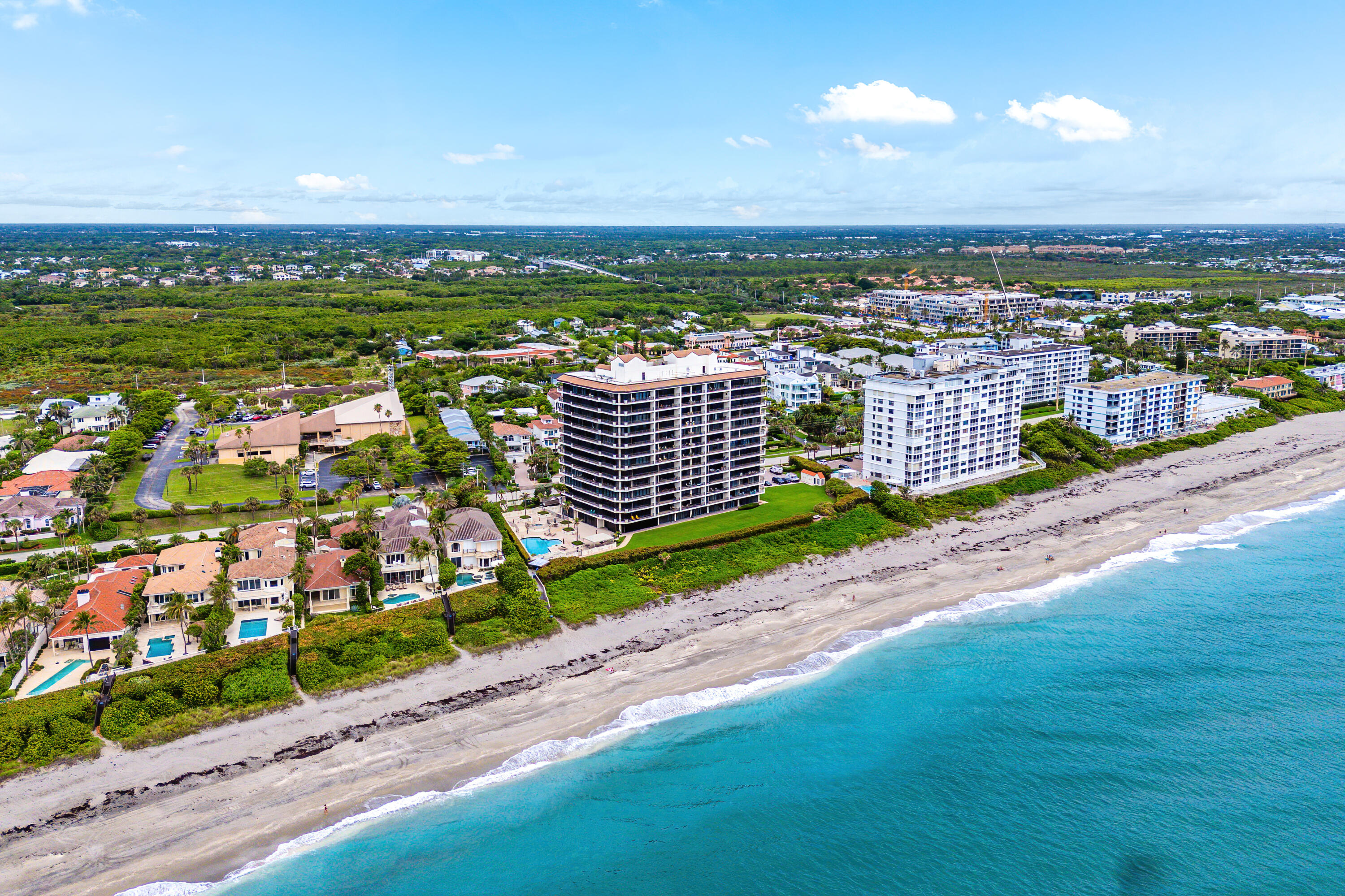 Welcome to Waterfront on the Ocean!   RARELY AVAILABLE PRIVATE ONE CAR GARAGE INCLUDED WITH PURCHASE OF CONDO.  BRAND NEW IMPACT WINDOWS AND DOORS. Wake up every day to stunning views of the ocean in one of the most coveted and peaceful coastal communities in Palm Beach County. Right on the sands of Juno Beach, this 2nd-floor condo in this boutique  building offers a front-row seat to some of the quietest and most pristine beaches in South Florida, far from the crowds, yet close to everything. From the moment you step off the elevator into your private foyer, you're greeted by a light-filled coastal sanctuary featuring  hand-painted French rag wash wall treatments and marble floors throughout. The spacious kitchen offers classic cabinetry, stainless-steel appliances, and a built in wet bar perfect for entertaining, especially when paired with those jaw-dropping ocean views.  Enjoy both the sunrise and sunset from your two private balconies, east-facing to catch the morning light, and west-facing to soak in a beautiful sunset. With 9-foot ceilings and thoughtfully designed living spaces, every inch of this home feels bright, open, and infused with ocean air. Additional perks include a private one-car garage and a second assigned parking space in the main garage, a rare luxury in oceanfront living.  Waterfront residents enjoy resort-style amenities including an on-site manager, fitness center, game and community room, oceanside pool, and garage parking. Pet friendly, too! Whether you're looking for a peaceful year-round residence or the ultimate beachfront getaway, this is Juno Beach living at its finest, where the beaches are quieter, the views are better, and the lifestyle is unbeatable. Live where others vacation!