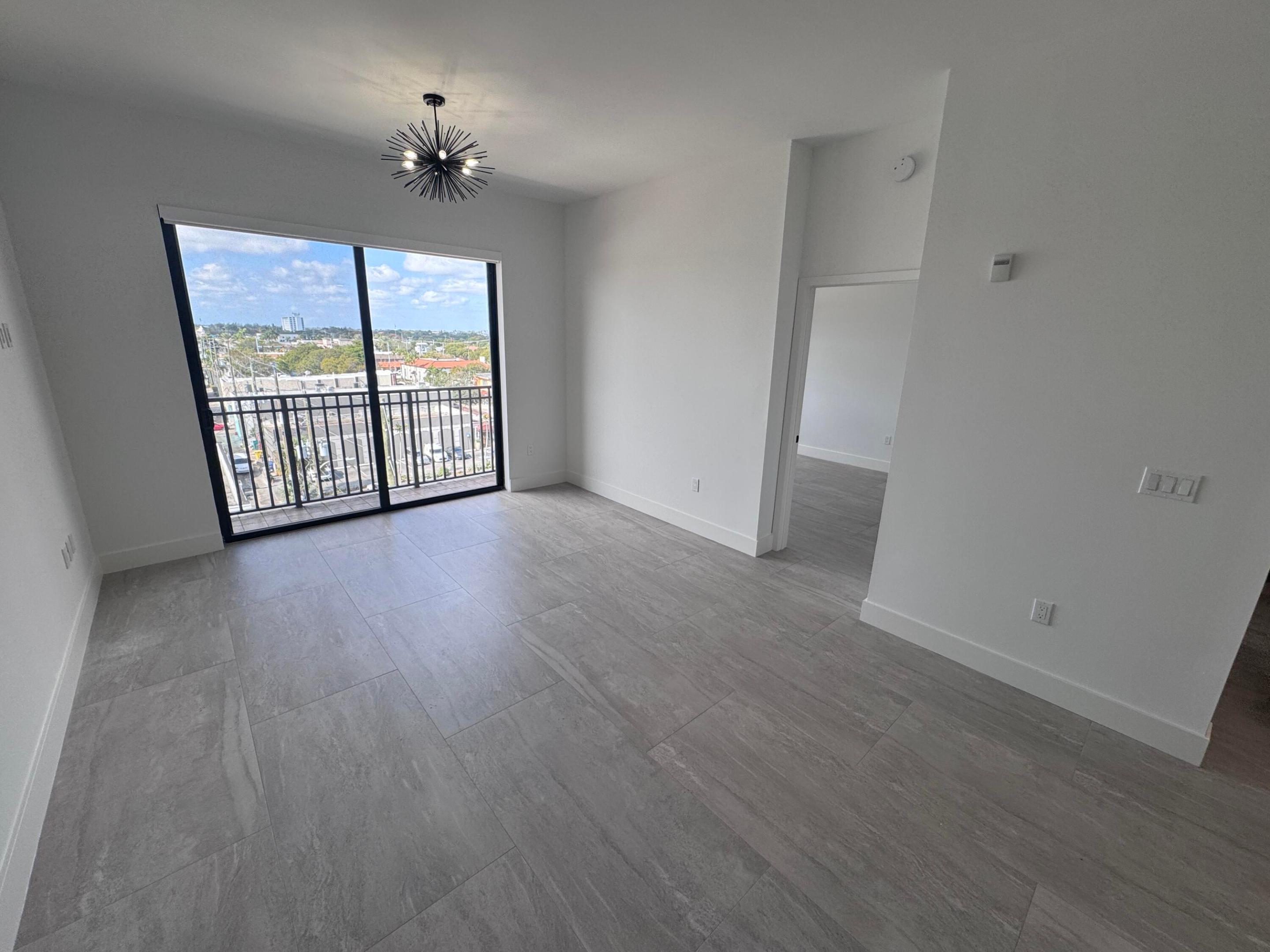 Step into luxury with this beautifully renovated, interior penthouse designed to impress. Enjoy soaring volume ceilings, elegant tile flooring throughout, and a sleek white kitchen featuring quartz countertops and stainless appliances. Unwind in the spa-inspired bathroom, complete with a separate soaking tub and shower, plus a stylish hanging cabinet. For added convenience, the unit includes a washer and dryer. Water and basic cable are included. Located in the heart of downtown Lake Worth Beach, you'll be just steps from vibrant dining, shops, parks, golf, and entertainment, and less than a mile from the beach. The building offers a fitness center and a stunning rooftop pool, along with an assigned covered garage parking space and additional street parking. Come take a look today.
