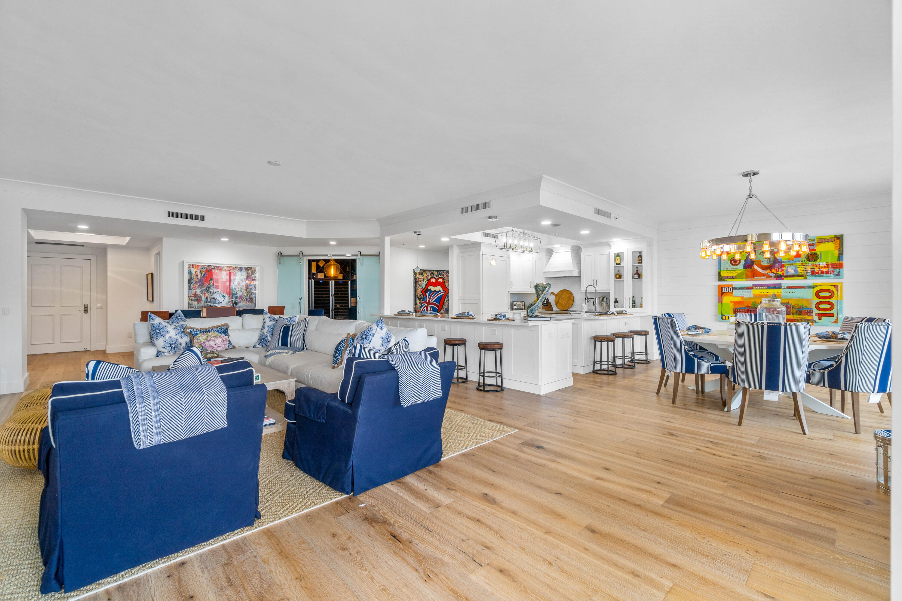Rare opportunity to rent a fully renovated, turnkey waterfront condo at The Pointe at Jupiter Yacht Club. Offering panoramic Marina and Intracoastal views, this unit is available immediately for a flexible lease term. Recently overhauled by well known decorator Pineapples & Palms, the interior boasts chic shiplap walls, sleek wood flooring, pristine white shaker cabinetry, high-end Wolf appliances, remote-controlled blinds, and a custom wine room in the den. Expansive floor-to-ceiling sliders illuminate the space with natural light, leading to a vast patio with breathtaking views. This luxurious home features three bedrooms with ensuite baths, a guest half bath, and a grand balcony ensuring privacy and serene vistas.  The Pointe at JYC offers upscale amenities including secure under-buildi