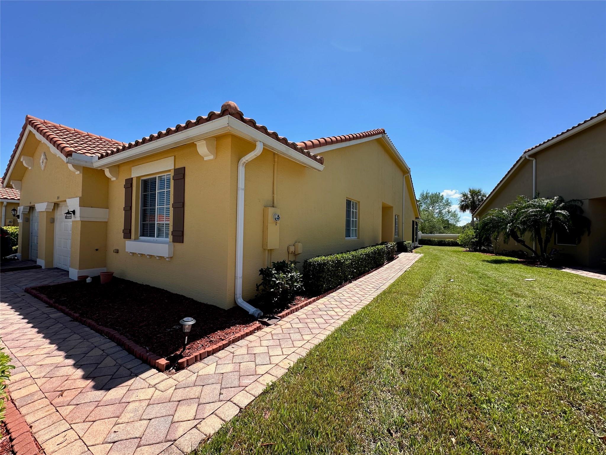 Largest Villa in Woodfield! Venice model...Move in ready! Side entrance opens to living/dining room with diagonal tile flooring, vaulted ceilings. Sliding doors off great room open to extended covered patio. This villa has plenty of space, feels like a single family home. Kitchen has an abundance of cabinets with crown molding and granite counters, snack counter and spacious breakfast area. Split floor plan. Master suite has beautiful engineered wood flooring, oversized walk in closet, master bath has 2 sinks & shower. Additional bedrooms #3 with plush carpeting and bedroom #2 with laminate flooring. Neutral tones throughout. This villa is conveniently located within walking distance to the community clubhouse with so much to do!