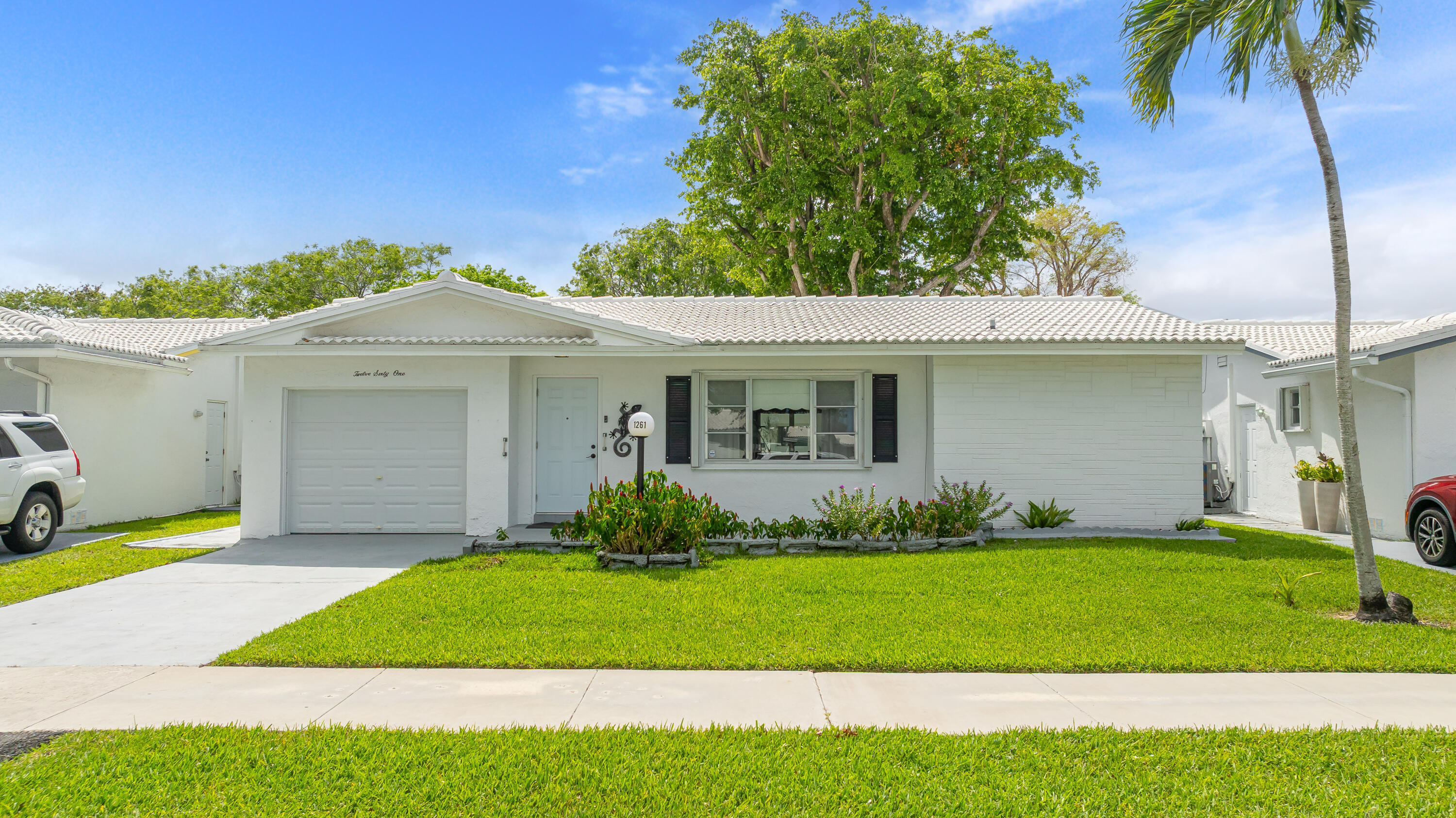 Welcome to Lauderdale West, an active adult community in the heart of Plantation known for its beautifully maintained grounds & outstanding amenities. The reasonable association fee covers lawn care, exterior pest control, house painting, basic cable/internet, roof repair & replacement, plus access to the clubhouse, fitness center, tennis, pool, shows, & social activities. This well-maintained home offers a split bedroom floor plan with both bedrooms featuring en-suite bathrooms. Spacious layout includes separate living, dining, and family rooms. Relax on the oversized covered and screened patio, approximately 26' x 10', perfect for enjoying South Florida living year-round. Accordion hurricane shutters provide added peace of mind. Don't miss this opportunity to call this house your home!
