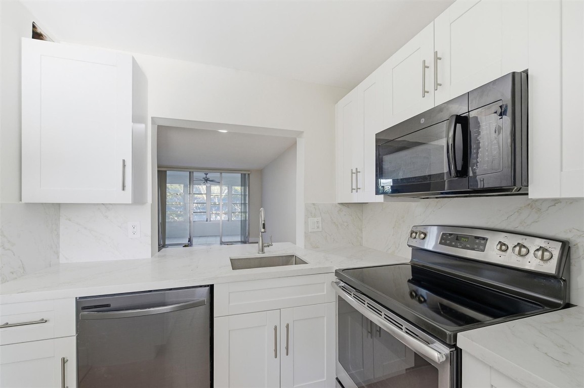 BEAUTIFULLY RENOVATED 2-BEDROOM RESIDENCE WITH SERENE WATER VIEWS FROM A PRIVATE SCREENED PATIO. This move-in-ready unit has been thoughtfully updated throughout, featuring brand-new kitchen cabinetry, quartz countertops, vinyl flooring, and fresh interior paint. Both bathrooms have been refreshed with new vanity cabinets, new grout, and new mirrors (coming soon). Additional upgrades include new baseboards, new ceiling fans, and new blinds for a clean, modern finish.Enjoy country club living with resort-style amenities, including golf, tennis, pickleball, fitness center, sauna, steam room, multiple pools, poolside sports bar, and formal dining.One pet welcome (20 lbs). Association requirements: minimum 650 credit score, DTI under 49%, 10% escrow deposit, and no leasing permitted. The current monthly condominium fee is $685, which includes a $75/month long-term assessment tied to a 20-year plan for major capital improvements that have already been completed, including the roof, concrete restoration, and exterior painting. A second special assessment is scheduled to begin August 2026 in the amount of $93 per month for eight years, designated for elevator modernization, parking area improvements, walkway painting, and landscaping enhancements. Additionally, residents enjoy a $175 annual food and beverage credit, usable at either of the two on-site restaurants.