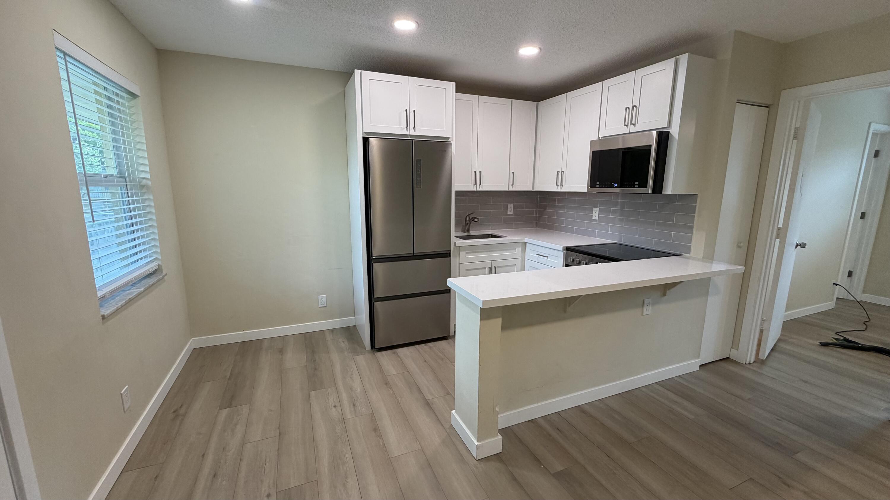 Welcome to this stunning, bright, and cozy 2nd floor condo! This Gorgeous unit has been updated in 2023/2024 with Waterproof Vinyl flooring, new kitchen/appliances, A/C and impact windows, Water Heater (6 months old). This meticulously maintained complex, residents have access to amenities including tennis courts, a sparkling pool, an exercise room, and more. Situated in a prime location close to shopping, dining, and entertainment, this beautiful condo offers everything you need for comfortable and convenient living. Don't miss out on this gem! Investors are welcome. 40 year certification is completed.
