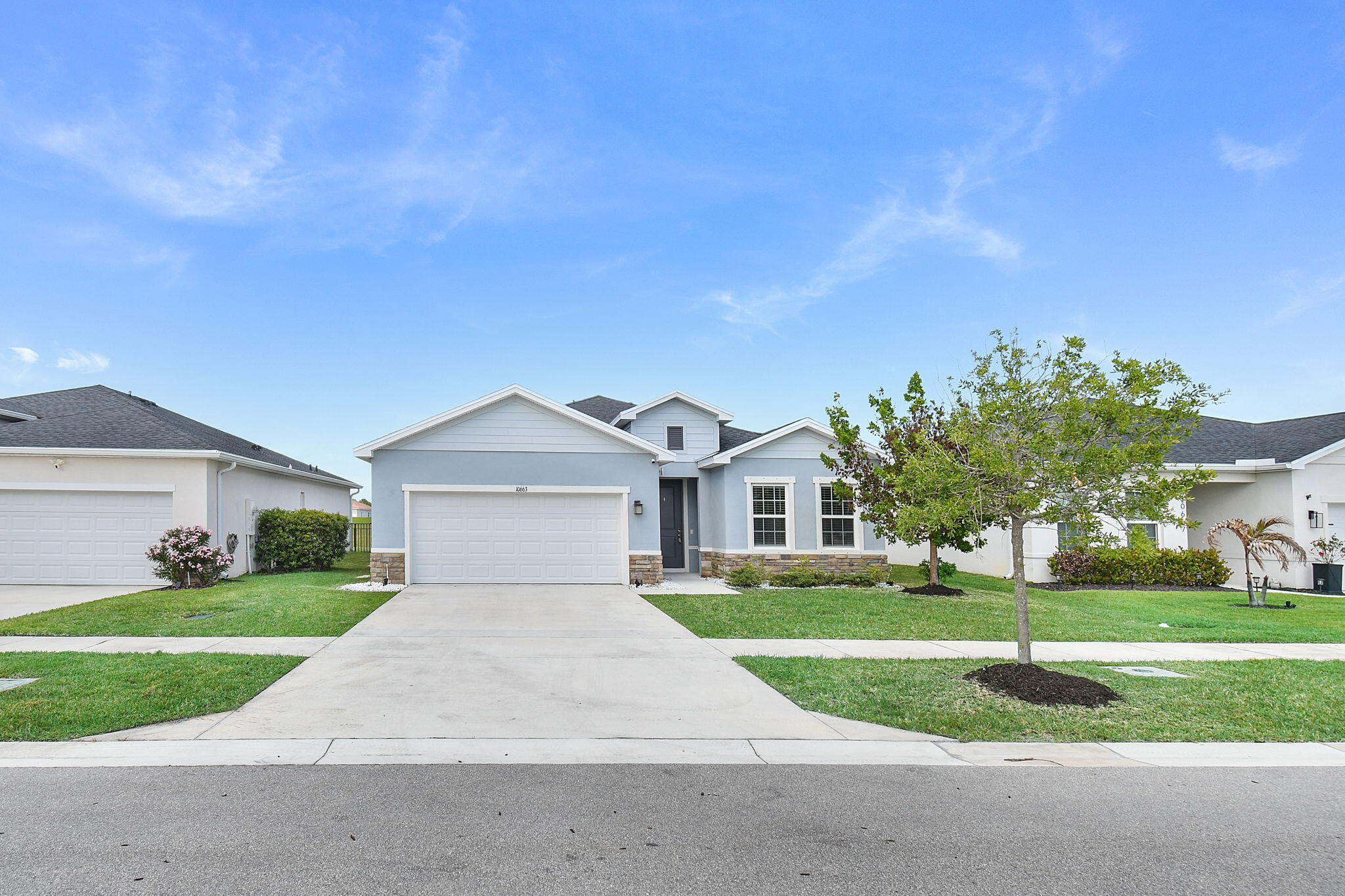 PRICE REDUCED!! Beautiful and spacious 3BR/2BA + den home built in 2022 by Ryan Homes, in the highly sought-after Crosstown Commons community. This thoughtfully designed home features upgraded porcelain tile flooring throughout main living areas, quartz countertops in kitchen and baths, stainless steel appliances including a smart refrigerator, and a large walk-in pantry. Additional highlights include a 2-car garage, hurricane panel shutters, and a fully fenced backyard perfect for pets, play, or relaxing outdoors. Crosstown Commons offers a quiet, family-friendly setting with amenities including a splash pool, cabana, and playground. Conveniently located just minutes from I-95 and close to Tradition and St. Lucie West for shopping, dining, entertainment, golf, and medical facilities.