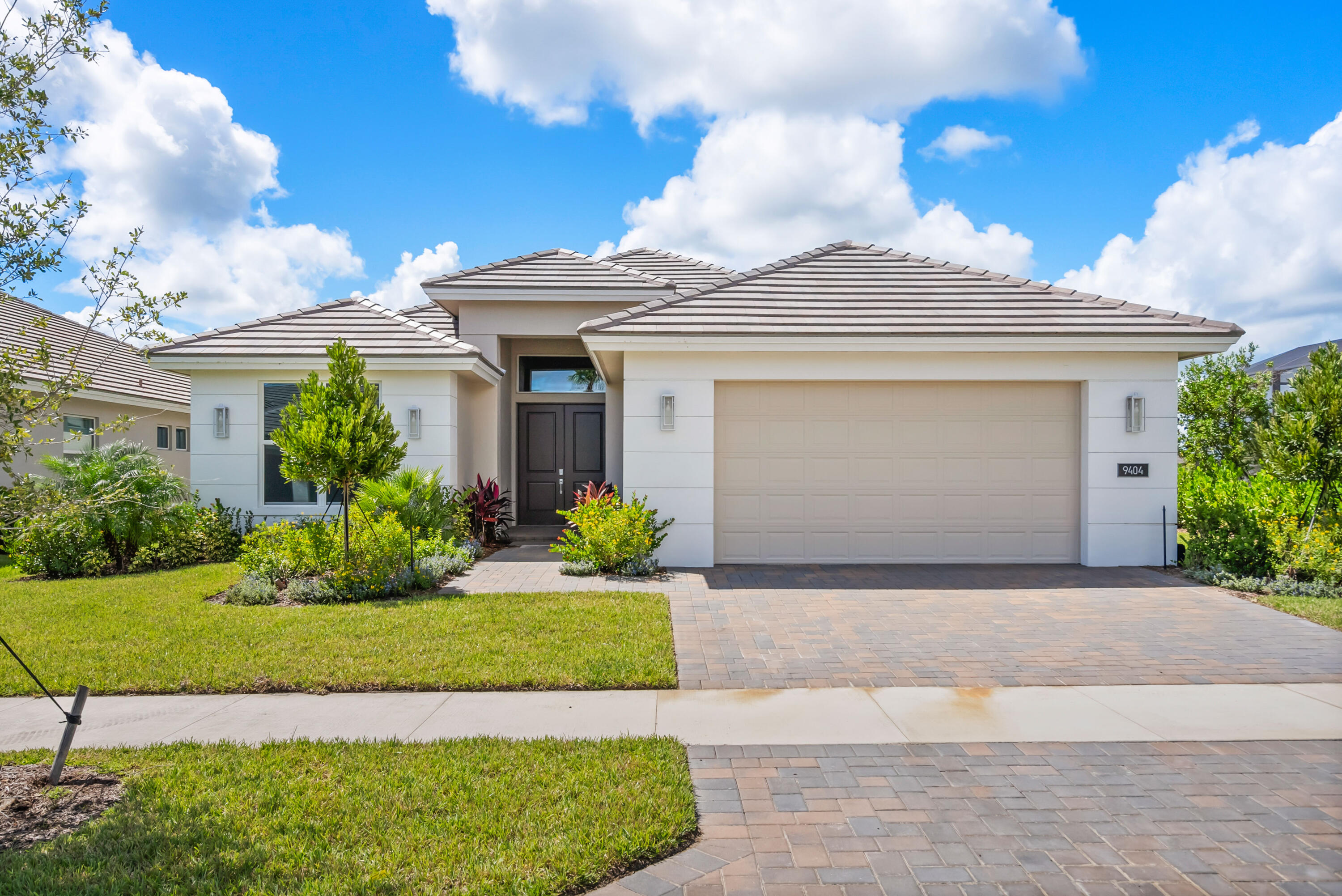 This move-in ready 3 bedroom, 2.5 bath home offers 2,241 sq. ft. of A/C living space and a total of 3,219 sq. ft., thoughtfully designed for comfort and style. The features GE Profile appliances, quartz countertops, a large single bowl sink, and a center island with a panel knee wall. Additional upgrades include a convenience package, designer backsplash, and pre-wiring for pendant lighting above the island. The den has been converted into a third bedroom, and a pocket door at Bath 2 creates a private ensuite for guests. The great room is enhanced with four recessed lights and a dedicated switch, while tile flooring flows throughout the home for a sleek, cohesive look. A 28' x 17'3" enlarged pool with three deck jets, a 16-foot bench, and an extended deck enclosed by a panoramic screen is perfect for entertaining or relaxing. The covered patio is prewired for a wall-mounted TV, adding to the home's outdoor appeal. With a north-facing contemporary elevation, stylish exterior finishes, and a three-car garage, this home blends luxury and functionality in a serene lakeside setting.   Located in Southern Grove, the new southern section of Tradition, BELTERRA is a boutique neighborhood developed and built by GHO Homes. This gated community offers a serene neighborhood. Residents can enjoy a clubhouse equipped with tennis, pickleball, and basketball courts, large gathering areas with wine lockers, a billiards and card room, a resort-style swimming pool, and a state-of-the-art fitness center. Additionally, the observation deck with a gazebo overlooking the picturesque Lake Belterra, provides a tranquil spot to relax and enjoy the natural beauty of the community.