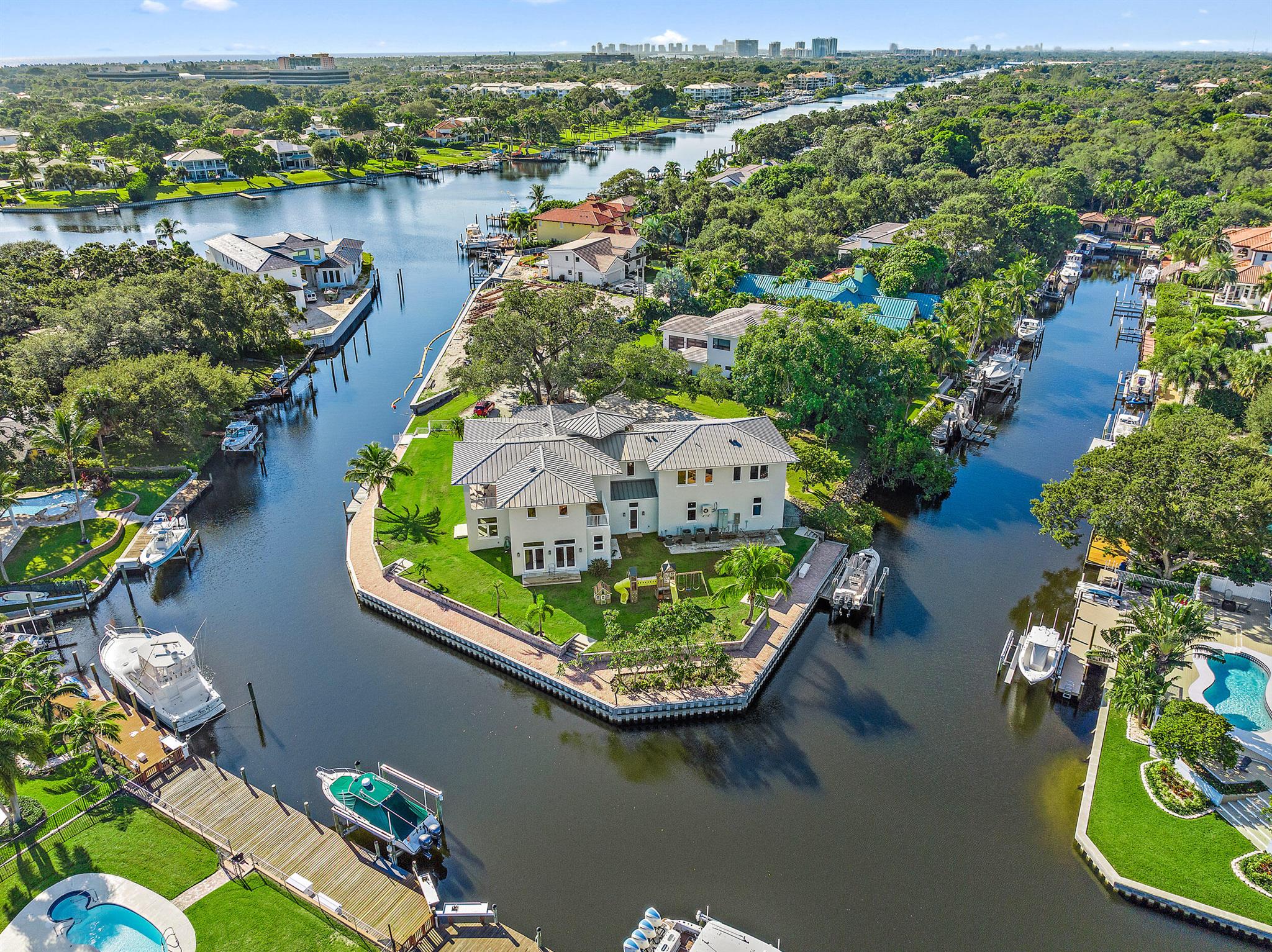 Located directly in the middle of North County this one-of-a-kind acre plus waterfront Point lot has over 400' of frontage, two docks & an 8,000lb boat lift. Designed with large spaces this home offers a ground floor mother-in-law suite, a 27'x18' game room with wet bar, & an expansive Chef's kitchen with top-of-the-line appliances, Silestone Quartz countertops, large center island & an eat-in breakfast bar. Adjoining the kitchen is a 30'x26' great room with an indoor/outdoor fireplace, Nano doors leading to the expansive covered loggia & views of the water. The spacious master bedroom has wood floors, large walk-in closets & his & her baths. The structure is CBS on both stories & has a poured concrete staircase & second floor slab. There's room for a pool off the kitchen great room.