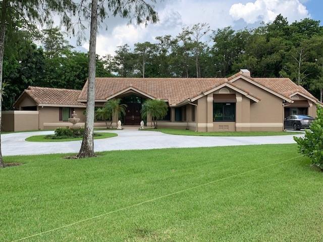 Live with immense privacy backing up to a forest like setting in this 4/3 1/2 bath home, with high ceilings and NO HOA to pester you.   Complete Impact windows and doors including insulated Impact rated garage doors with Web optimized openers.   We are just a short way off Holmberg so you don't have a long drive down a rocky street to get to your home.  The Barrel tile roof was finished in early 2016.   There is a private Office/Nursery/Exercise room off the master area.   The kitchen has Thomasville Furniture grade Cherry cabinetry throughout.    See Supplemental Remarks for many more details.  a 12 by 20 Air conditioned storage building was built on site in 2020.  The home has a 3 car Air conditioned garage that is oversized.  The home has an RV space with a 50 AMP circuit. *4 Bedroom 3 and a half bath home with additional office/nursery/exercise room/craft room off of Master suite. Two bedrooms share a Jack N Jill bath.   The fourth  bedroom has its own private bath with access to the pool area. The home has a three car air conditioned garage, and a 12 by 20 air conditioned storage building.  There are three zones of air conditioning in the home. *The barrel tile roof replacement was completed in 2016  (permit date 8/2015)*All windows and doors including the insulated impact garage doors were replaced in 2018 with impact rated windows, French doors  and Main entry doors.   *11 foot ceilings throughout most of the home (One bedroom has an 8 ft ceiling) and the Master is vaulted.*Built in 1993 with pool added in 2001, the home was painted inside and out in 2017. Crown molding was added at that time.  *Solid wood Cherry floors and Thomasville Furniture grade Cherry cabinets in the kitchen and master bath.  All new  Kitchenaid appliances in kitchen as of 2018, including an induction cooktop, 42 inch built in cabinet depth refrigerator and in wall oven/microwave combo and dishwasher.  * 50 foot RV/Boat parking pad with 50 amp hook up.  NO HOA or restrictive covenants