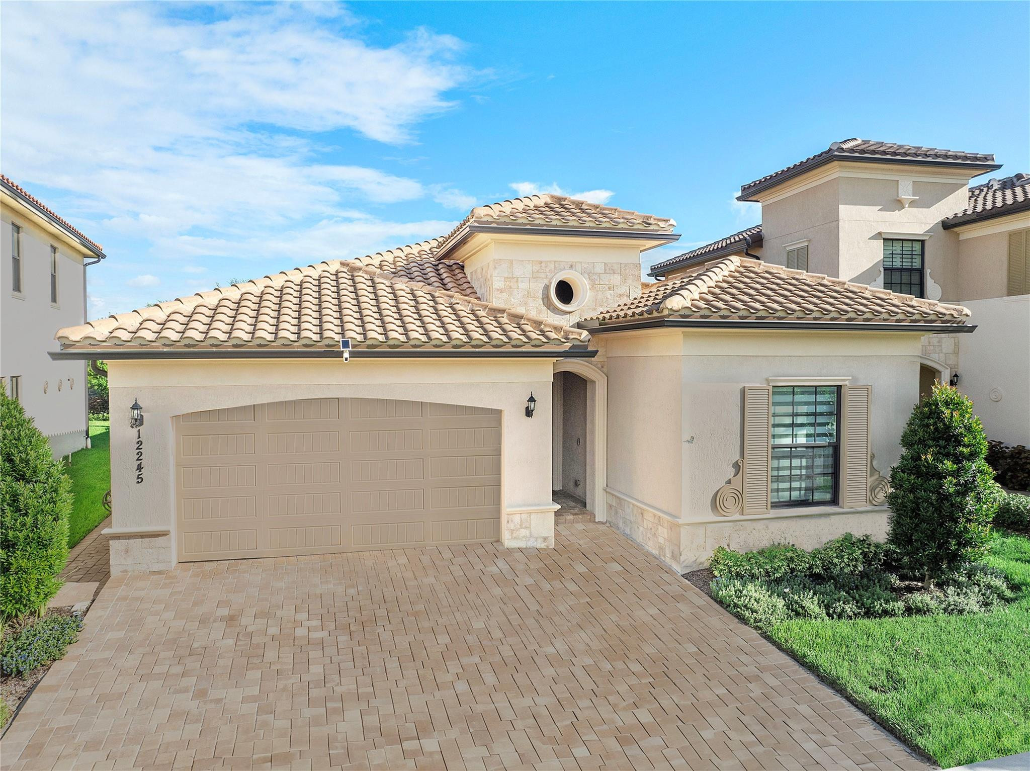 BETTER THAN A MODEL HOME! Stunning 3 bedroom + den/flex room, beautifully upgraded 2021-built Meadowlark model behind the guard-gated entrance of Parkland Bay, one of Parkland's most desirable communities. Open-concept layout filled with natural light, electronic shades with white draperies, and 21x21 porcelain tile throughout. Chef's island kitchen boasts GE SS appliances, gas range, custom quartzite counters & backsplash, and a walk-in pantry with custom shelving & glass door — flowing into spacious living & formal dining areas, ideal for entertaining. Custom zebra blinds throughout. Primary suite features backlit mirrors, custom closets, and a spa-like bath. Oversized garage with epoxy flooring. Tankless water heater. Oversized lot on a berm with extended driveway for added privacy. Gas community adds everyday convenience & efficiency; newer construction means peace of mind & energy savings. Parkland Bay offers a grand clubhouse, fitness center & pool. Nothing standard about this home!