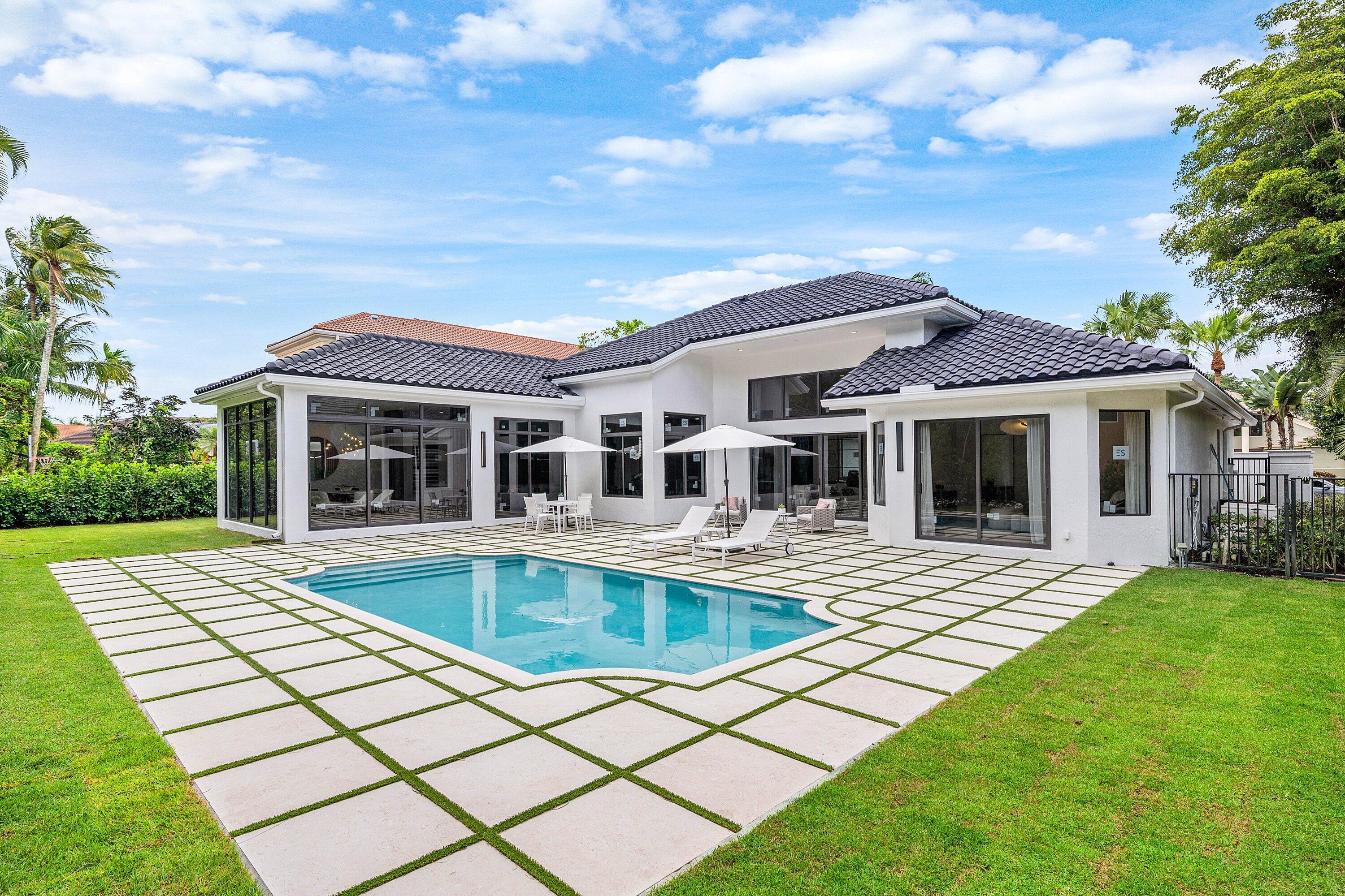 Welcome to CASA MANDARIN, a fully reimagined residence in prestigious Boca Grove Country Club. Privately set on an oversized lot, a rare Boca Grove offering, this exceptional home blends sophisticated design with effortless indoor outdoor living. Featuring 4 bedrooms plus an office and a resort style backyard, the home is designed for both entertaining and everyday luxury. Highlights include a stunning Italian marble kitchen with thoughtfully designed dual layout featuring double oven, double dishwasher & sink,premium Thermador appliances, new impact windows and doors, hardwood flooring, custom vanities, designer lighting, and a dramatic floor to ceiling fireplace feature wall. No detail was overlooked, making this turnkey residence the ultimate private retreat. Just bring your toothbrush.