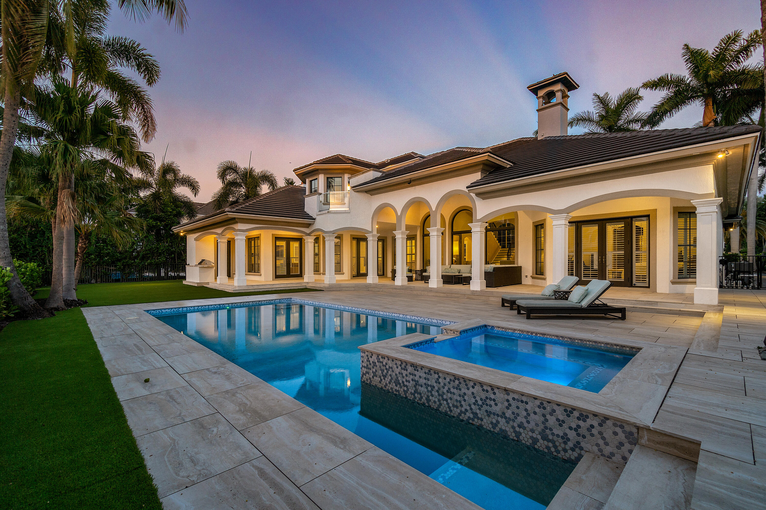 This stunning furnished home in prestigious Royal Palm Yacht club offers a prime location on the golf course with panoramic views. The home has been remodeled with exquisite taste & attention to detail, featuring high ceilings, impact glass windows and doors, and a new roof installed in 2020. The kitchen is a chef's dream with calcutta marble countertops, viking gas stove, sub zero refrigerator and large wine storage. The master suite is on the first floor and features wood flooring and a spa-like bathroom w/ 2 water closets  The downstairs also boasts a rich wooden paneled library. Upstairs are 3 ensuite bedrooms and  cozy loft,area  The backyard is an oasis of relaxation and entertainment, with a large covered loggia, heated pool, spa & summer kitchen