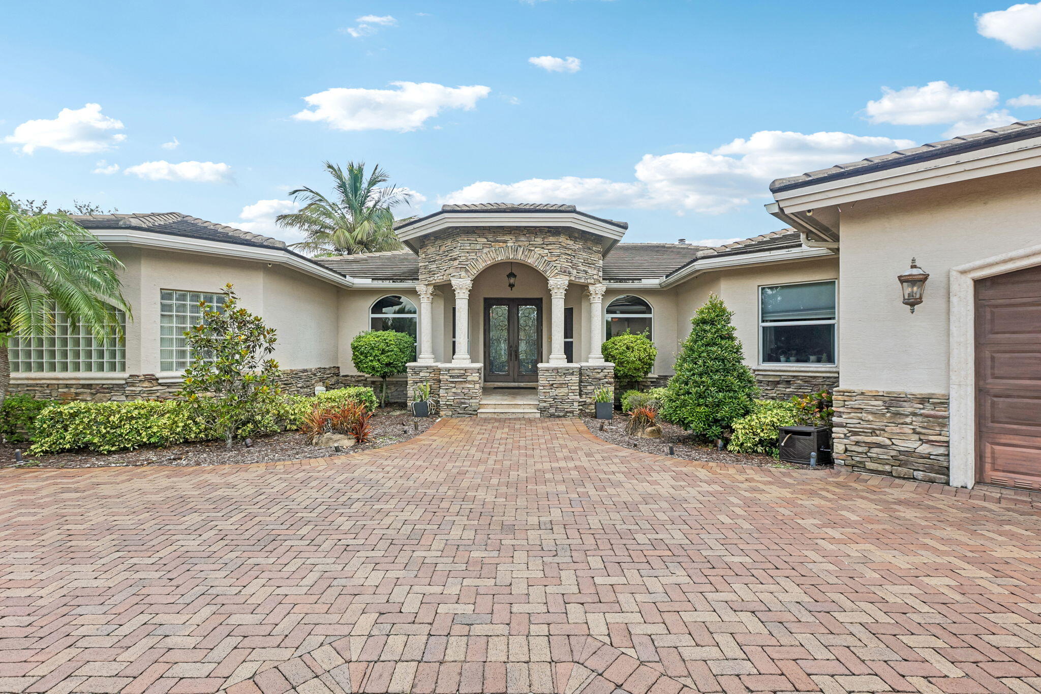 Rare opportunity to own a custom-built estate that seamlessly blends luxury, functionality, and resort-style living on a private 1-acre homesite.  Thoughtfully designed in 2007, this residence offers exceptional indoor-outdoor living with high ceilings, marble flooring, a private media room, and a layout that perfectly balances everyday living with effortless entertaining.   Outside, enjoy your own private retreat featuring a heated saltwater pool and spa, covered outdoor living, fire pit, and lush tropical landscaping.   Complete with impact windows, 6-year-old roof, solar panels with Tesla power back up generator, two oversized 2-car garages, and an expansive driveway—offering comfort, efficiency, and peace of mind year-round.  AGENTS PLEASE READ BROKER REMARKS