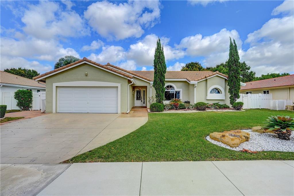 Beautiful move in ready 2 car garage home in the heart of Coral Springs! Walking Distance to "The Walk" with lots of shopping, restaurants and bars.  Home features Impact Windows Through out, Updated soft close Kitchen Cabinetry, Updated Bathrooms and well maintained Roof (2009) . Screened in Porch with Large Fenced in Backyard containing beautiful fruit trees (Avocado and Mango) with enough room for a pool. Primary Bedroom with walk in closet, closet built ins and an updated primary bathroom with dual sinks along with updated second bathroom.