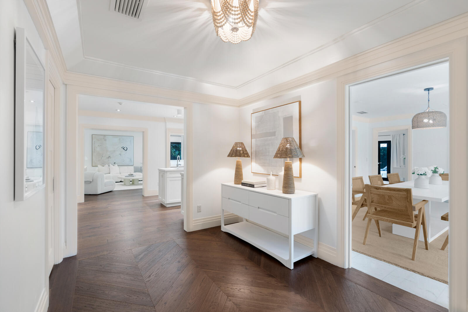 Located on a quiet street in Palm Beach's North End, this modern beach house offers 3,803± total square feet with four bedrooms and four and a half bathrooms. Set on a 12,206± square foot lot, the property features a large pool, spacious yard, and an air-conditioned two-car garage.

The interior blends comfort and coastal style, with wood flooring throughout the main living areas and marble finishes in the bathrooms. The living room opens through sliding glass doors to the pool and patio area, creating a natural flow between indoor and outdoor spaces. The kitchen includes a breakfast area, full-size Sub-Zero refrigerator and freezer, double ovens, and an electric cooktop. The adjacent dining room overlooks the lushly landscaped grounds. Three bedrooms are located on the main level, each with en suite baths and closets. The primary bedroom features two walk-in closets and French doors that open to the pool. Upstairs, a private guest suite includes a balcony overlooking the pool and an en suite bath.
A separate deeded beach parcelapproximately 2,000± square feet (35' x 56') is available for purchase separately. A pathway accessible from the side of the home leads directly to the private beach parcel.