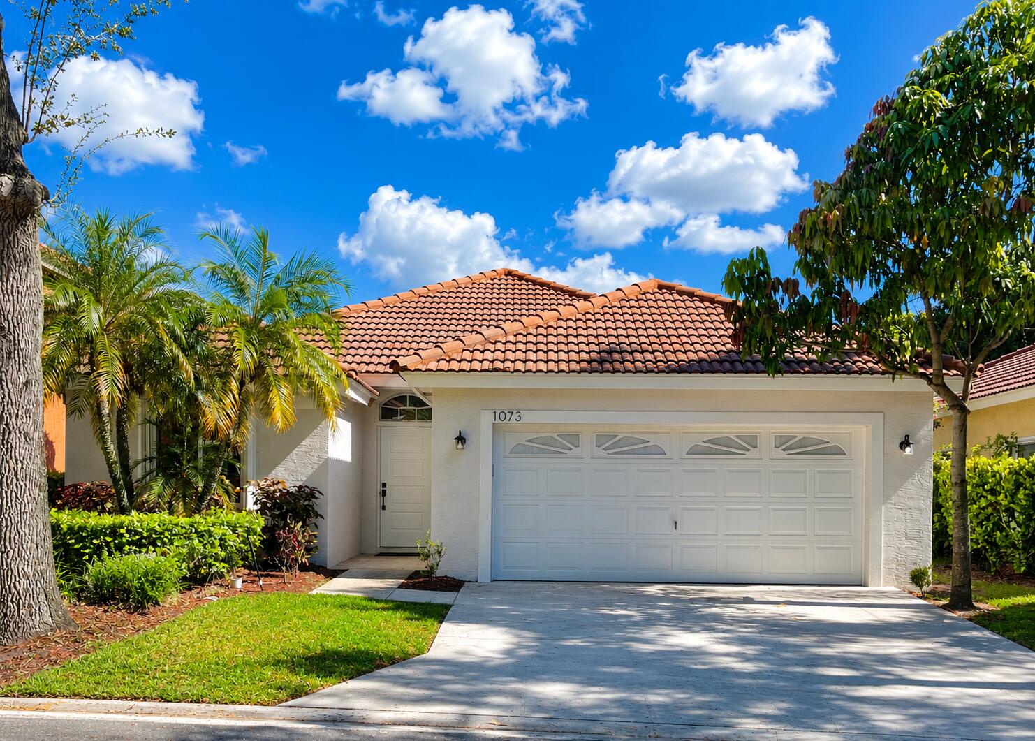 Welcome to this beautifully renovated 3-bedroom, 2-bath move-in ready lakefront gem, located in the gated community of Woodbine. This exceptional single-story home features a brand-new roof (2026), impact windows (2025) & water filtration system (2025), providing long-term value. A stunning designer kitchen features a large center island, ample storage, generous prep space, and seating. The open-concept layout seamlessly connects the kitchen, dining, and living areas, maximizing both functionality and views. The primary suite serves as a private retreat, complete with a spacious custom-designed walk-in closet and contemporary designed bathroom. Residents of Woodbine enjoy resort-style amenities while just minutes away from premier shopping, beaches, I-95 & more.