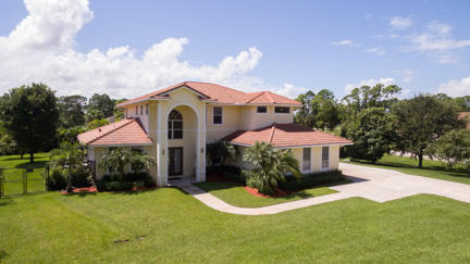BEAUTIFUL, WELL MAINTAINED 2 STORY CUSTOM BUILT MEDITERRANEAN STYLE HOME. JUST OVER 3000 SQ. FT. LIVING AREA, ON OVER AN ACRE AND LOCATED ON A PAVED ROAD. 4 BED (4TH BEDROOM DOWNSTAIRS FOR GUESTS OR MULTI FAMILY LIVING) 3 BATH AND A TRUE 3 CAR GARAGE.  A TRUE CULINARY HAVEN, DOUBLE CONVECTION OVENS, INDUCTION COOKTOP, PREP ISLAND AND WALK IN PANTRY. DOWNSTAIRS 10' CEILING, ENGINEERED WOOD FLOORING , BUILT IN SURROUND SOUND, OPEN FLOORPLAN WITH EXPANS IVE VIEWS OF POOL, SPA, LARGE PATIO AREA AND TIKI. TWO A/C'S '21, WATER HEATER '25, POOL HEATER '23, EXTERIOR PAINT 2018. BACKYARD IS DOUBLE FENCED, 20' ARECA PALMS FOR PRIVACY, ENTIRE YARD HAS ZONED IRRIGATION. EXPANSIVE DRIVEWAY WITH ADDITONAL CAR PAD SO GARAGE IS NOT BLOCKED.  SPACIOUS PRIMARY BEDROOM, HIS/HER CLOSETS IWTH CUSTOM BUILT INS RAINFALL SHOWER, SPA TUB  SEPERATE HIS AND HERS VANITIES. CONVENINETLY LOCATED JUST OFF OF 110TH AVE FOR EASY ACCESS TO NORTHLAKE, TURNPIKE AND 95 FOR EASY COMMUTING. CLOSE TO NEW AVENIER  AND WESTLAKE TOWN CENTERS FOR SHOPPING (BRAND NEW PUBLIX) AND DINING.