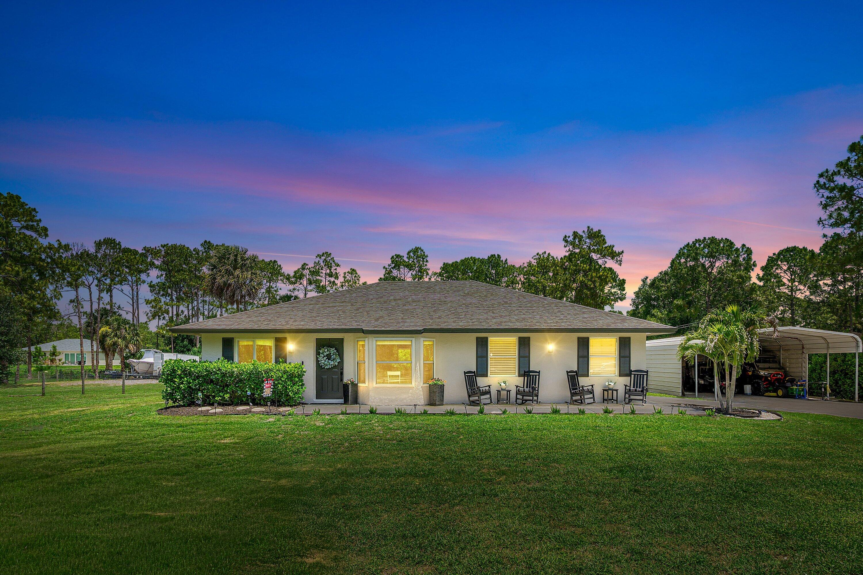 This move-in-ready 3BR/2BA home sits on a fully fenced 1.16-acre lot offering modern upgrades and true acreage living. The open-concept layout features new flooring throughout main living area going into the master bedroom. All-new baseboards, fresh interior and exterior paint, a new hurricane-impact front door, and impact windows on all but two openings. Additional updates include a newer A/C system, newer hot water heater, and the roof was replaced in 2022. Outside, enjoy a massive backyard, new landscaping, large concrete driveway, oversized covered patio, air-conditioned garage with epoxy floors, and a 20x30 shop. No HOA and plenty of room for boats, RVs, and toys. Ideal blend of comfort, function, and privacy.