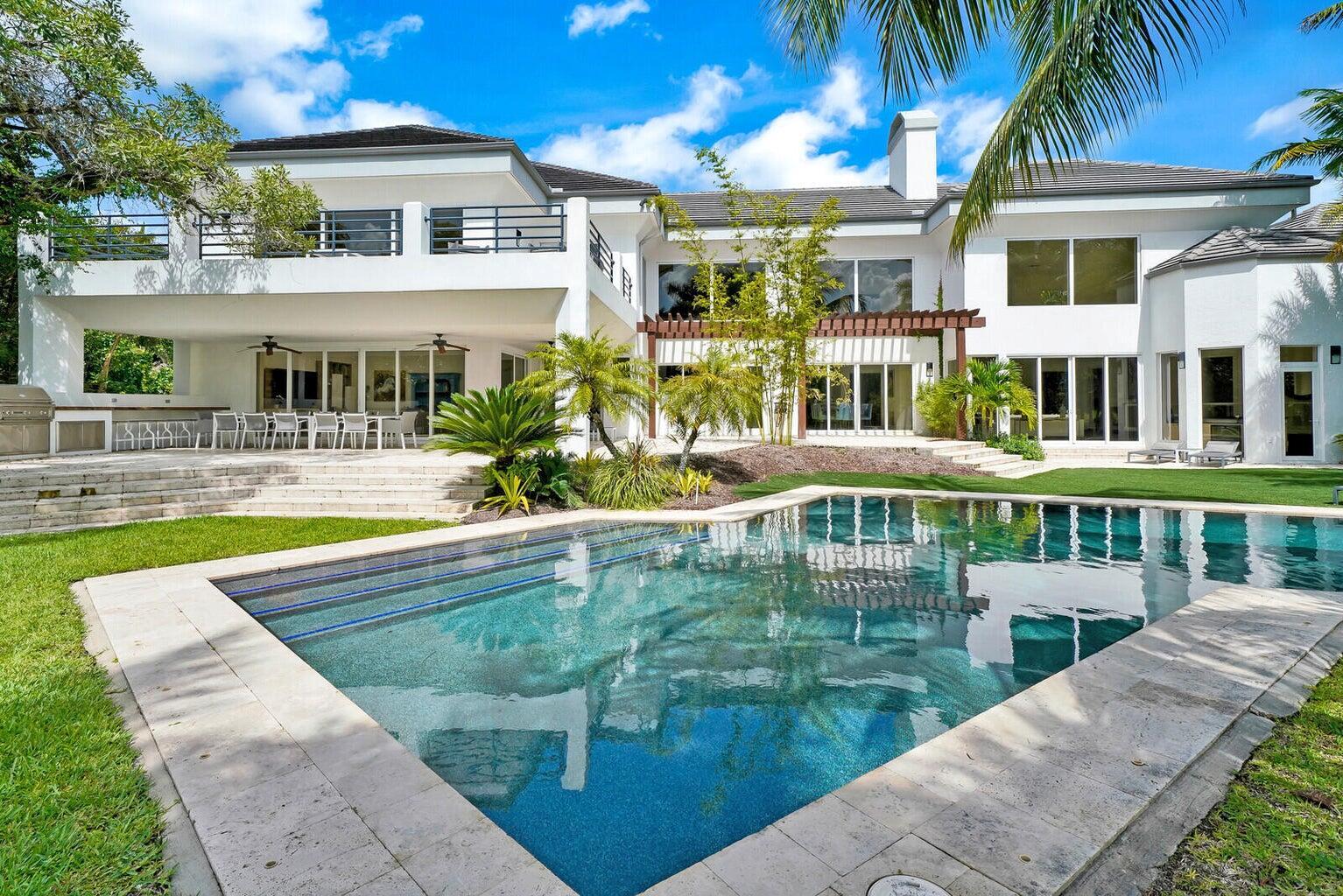 Exquisite estate home located in the exclusive Palm Beach Polo Club. Recently undergoing a complete remodel and featuring 5 beds & 6.2 baths. Floor-to-ceiling windows fill the home with natural light accentuating the luxurious finishings throughout. Gourmet kitchen with Thermador appliances, walk-in pantry, and built-in wet bar. Oversized primary suite with stunning pool views and a spa-esque feel. Upstairs hosts a bonus living area with a kitchenette, 2 guest suites, and a balcony overlooking the pool. Outside, you can find a pool with a spa, a built-in grill, and ample living space. New roof, air conditioning units, water heater, impact glass, landscaping, & more. Beautify maintained and ready for its new owner!
