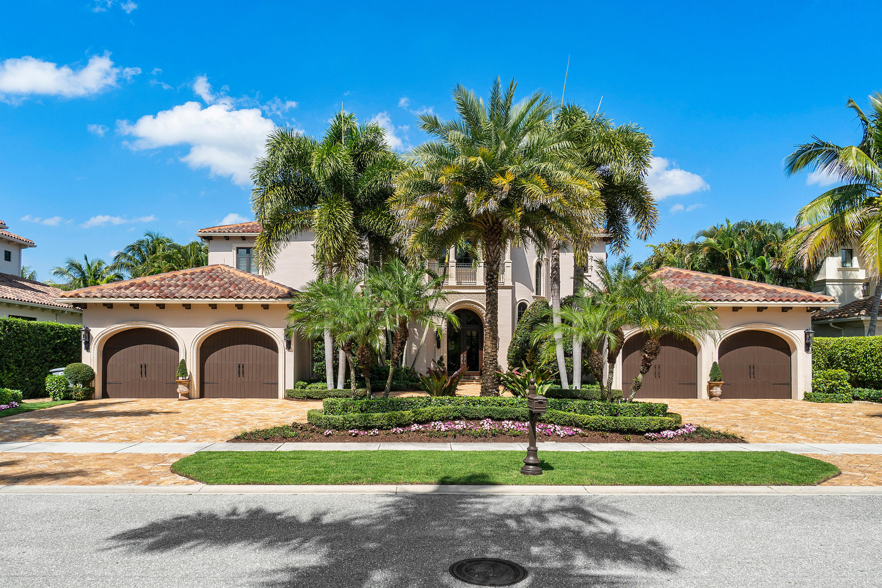 This expansive custom-designed estate offers exquisite finishes and craftsmanship that are a RARE find. Upon entering the voluminous foyer with a dramatic staircase you are greeted by the striking sun-filled living room with impressive vistas of the sparkling pool and lake. A culinary chef's dream, the kitchen offers gourmet appliances from Subzero, Wolf, Thermador, and Miele and a spacious walk-in pantry. With a seamless transition from the family room and quaint dining area to the club room, take note of the impressive finishes and custom woodwork throughout. A primary owner's wing on the main level of this nearly 7,000 SF home leads to a comfortable yet grand office/den. Approaching the owner's suite, the spectacular design and visual interest continues with dual luxurious bathrooms and walk-in closets that exceed expectations. The owner's suite has a private connection to the outdoor living space that reveals a resort-style saltwater pool and spa, putting green, luscious landscaping and long lake views. The loggia encompasses an outdoor living room with a bar and summer kitchen that takes entertaining to a whole new level. Up the grand staircase, you'll find a living room loft with gorgeous balcony views of the property and four spacious en-suite bedrooms, all unique in character. Located on a tree-lined estate section in The Oaks, this gated community offers resort lifestyle amenities including a private restaurant, gym, spa, and award-winning tennis facility that encompasses a 25,000 SF renovated clubhouse.