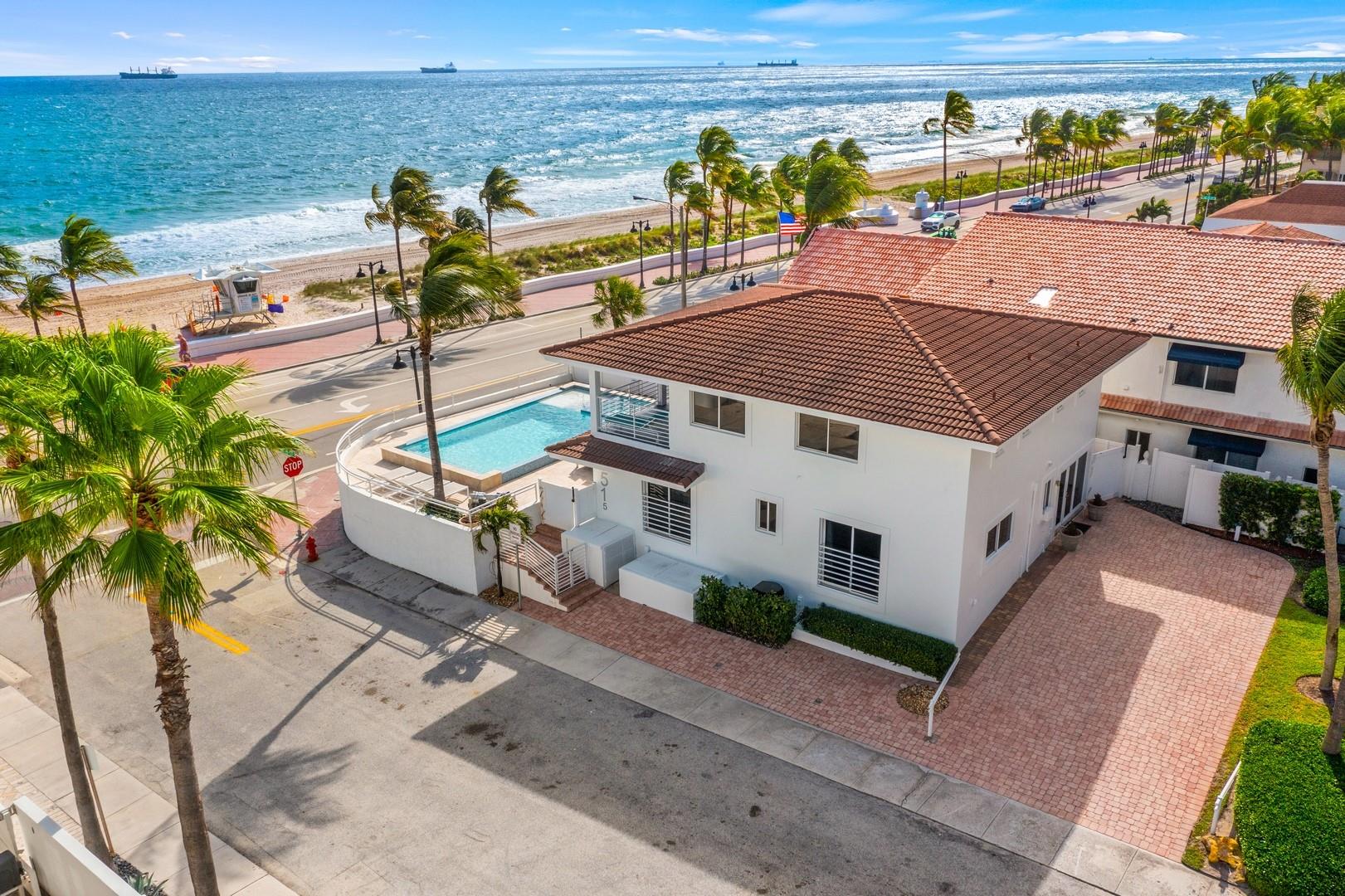 The most affordable beach house in Fort Lauderdale! Enjoy expansive wide open ocean views from highly elevated corner residence (great views from many rooms)! Across from one of the best beaches & in the heart of Fort Lauderdale's beach life, nearby restaurants & shops. Stunning double-edged infinity salt water heated pool & jacuzzi, perfect for outdoor oceanside entertaining. Sold furnished (exclude art) ultimate floorplan flexibility, expansive chef's kitchen with dining island & large, bright living room. 1st level offers one bedroom suite & potential 4th bed/office, full bath. 2 upstairs bedrooms are studio apartments, ensuite baths, kitchenettes & large covered balcony, perfect to watch the sunrise! 6+ car parking, currently being used as a second home and AirBnB rental.