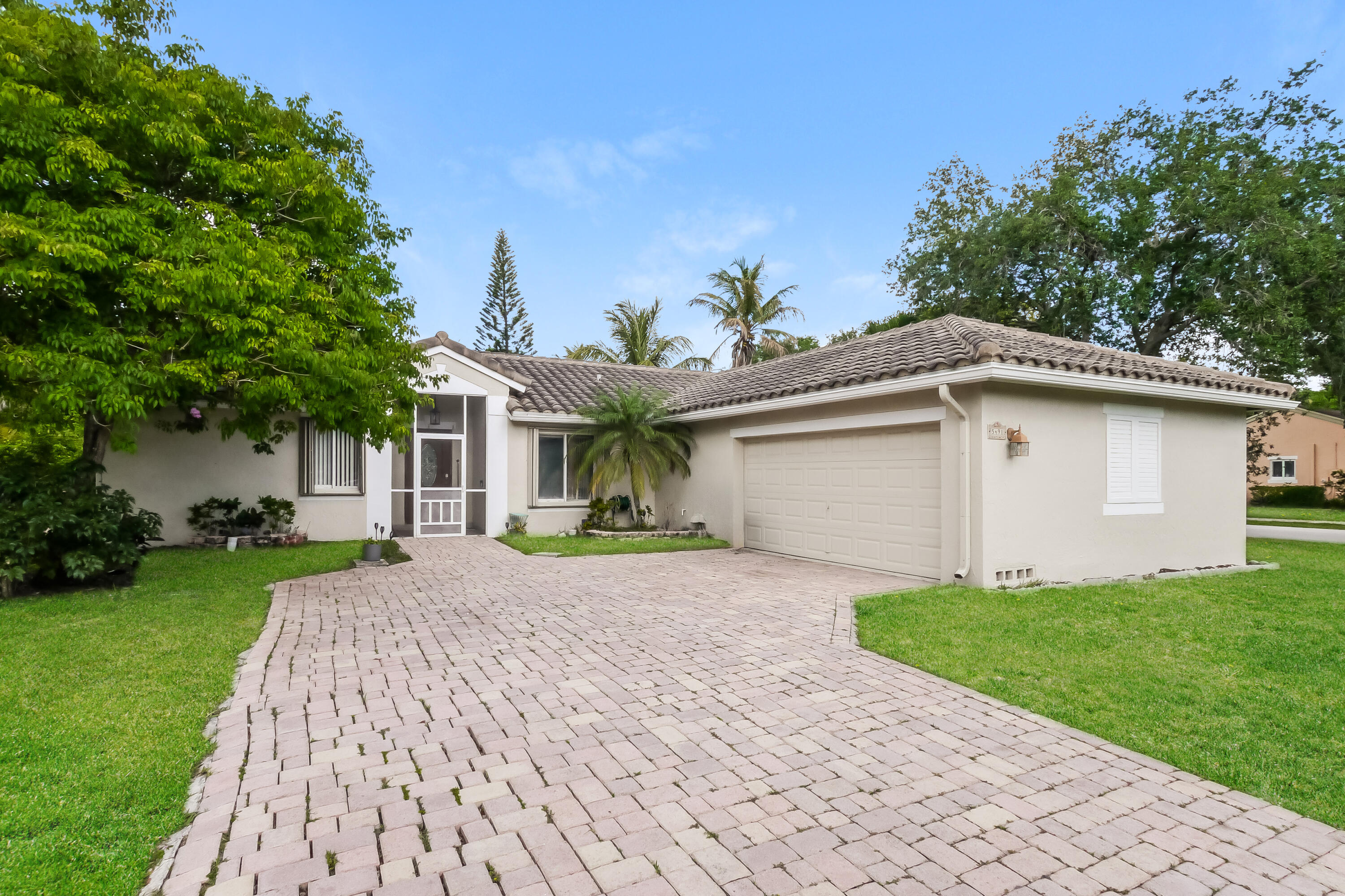 Beautifully remodeled 3-bedroom, 2-bath home located in a quiet, desirable neighborhood in Coconut Creek. This move-in ready property features a bright and open layout with modern upgrades throughout, including an updated kitchen, stylish finishes, and refreshed bathrooms. Enjoy Florida living at its best with a private screened-in patio and sparkling pool—perfect for relaxing or entertaining year-round. The spacious backyard offers plenty of room to unwind and enjoy the outdoors. Conveniently situated just minutes from major highways, shopping, dining, and top local amenities, this home combines comfort, style, and an unbeatable location. Don't miss this exceptional opportunity!