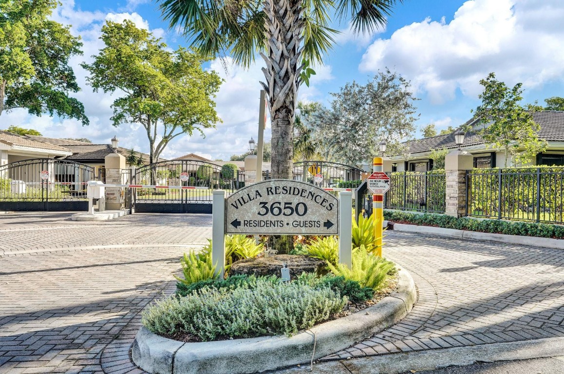Located in a Gated Community, this well-appointed Villa offers a prime Location with panoramic Golf Course views and abundant guest parking. The open and airy floor plan creates an inviting atmosphere from the entry, with expansive views throughout the main living areas. A flexible Bonus Room may be utilized as a Home Office, or Family Room. The freshly painted interior features an upgraded Kitchen with Wood Cabinetry, Granite Countertops, and additional built-in storage including a Pantry. Additional features include a two-car Carport with ample Storage, hurricane accordion shutters, space for large backyard future Patio build-out. This convenient location just steps away from the Community Pool.