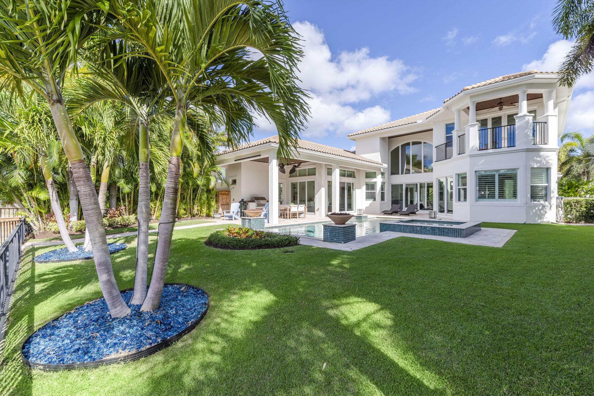 Exemplifying the pinnacle of waterfront luxury living, this stunning 4 bed, 5 bath residence redefines elegance in the exclusive enclave of Frenchman's Harbor. The home is situated on a private waterway with a premium $75k floating dock capable of accommodating a 65' vessel. No fixed bridges and easy ocean access enhance the allure of this boater's paradise. Upon entry, natural light floods the interior through floor-to-ceiling windows, illuminating the open-concept living space. Newly installed hardwood floors sweep across the great room and into the other living areas. The main level hosts a grand primary suite with water and pool vistas, dual walk-in closets, and a newly renovated spa-like bathroom. Upstairs features a second master suite with a private covered balcony... and two additional bedrooms complete with ensuite baths. The expansive chef's kitchen has been completely redesigned, adorned with top-of-the-line Subzero and Wolf appliances, waterfall quartz countertops, and separate bar area which seamlessly connects to the oversized family room and extends to the lanai overlooking the lush backyard and serene water view. 
Outdoor living is a year-round delight, with a heated saltwater pool, spa, gas fire pits, fountains, and full summer kitchen, all set against the backdrop of a spacious backyard. 
Frenchman's Harbor is the premier gated waterfront community of North Palm Beach, offering intimate living with only 48 single-family homes and 30 carriage homes. Enjoy the proximity to Florida's pristine beaches, Juno Beach Pier, and local restaurants. Boating enthusiasts will appreciate the 15-minute access to the Jupiter Inlet and the allure of the Bahamas just 50 nautical miles away. This spectacular residence epitomizes the best of coastal living in the Palm Beaches.