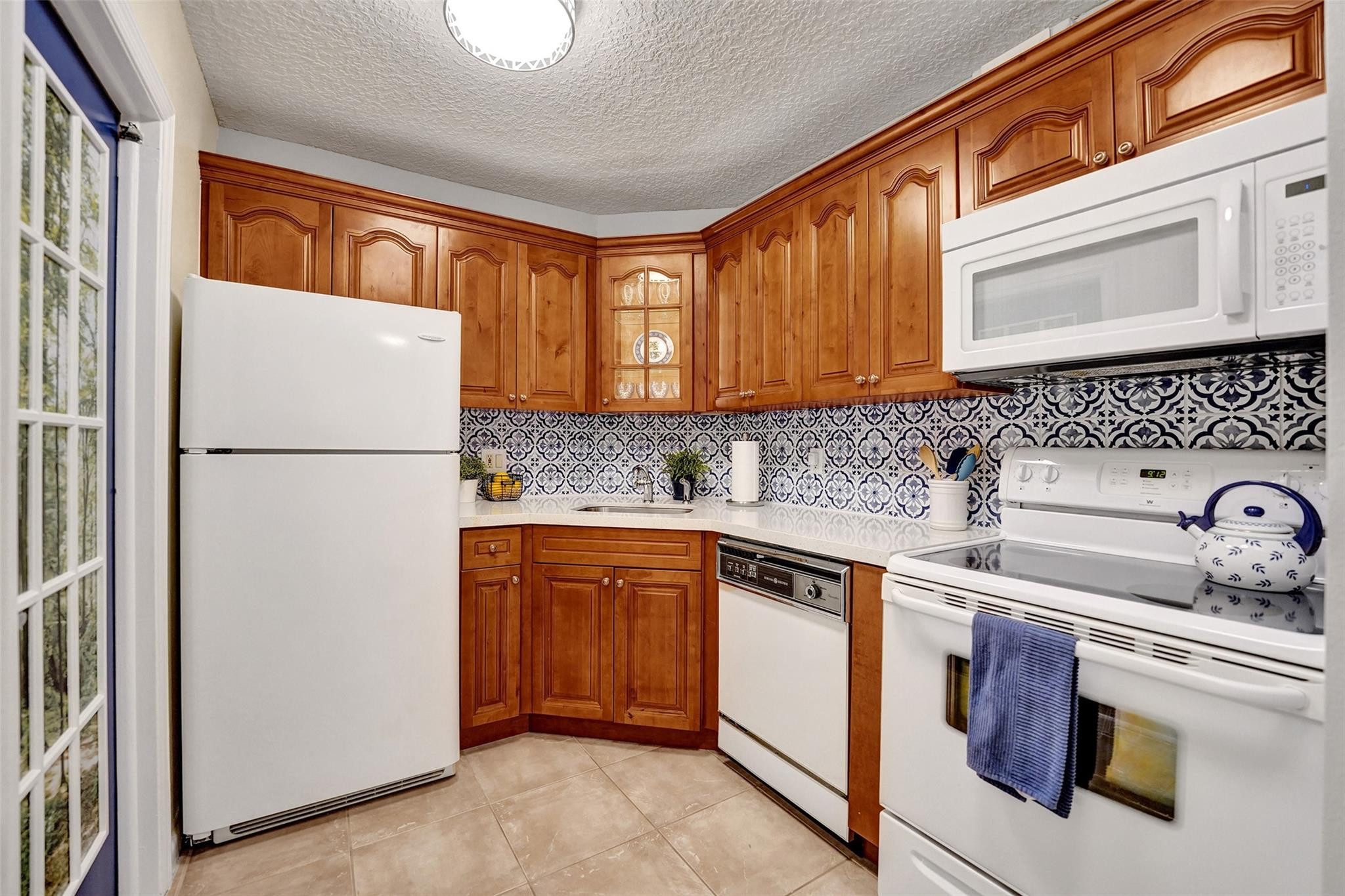 Manor Grove Village Two - No land lease, washer and dryer allowed to be installed, lowest priced maintenance fees in Manor Grove complex. 650 credit score required per association, 1 pet OK under 20lbs, large master bedroom with walk in closet, Quartz Kitchen counter - 2023, quartz bath vanity - 2023, AC air handler-August/2024, roof condenser-2020, Rheem Water heater-2021 with expansion tank, flooring-2021, microwave-2020, beautifully maintained and ready to move in, no leasing 1st year of ownership then rent limit. Community room with kitchen facilities, mens and womans sauna, storage cage on 2nd floor, Located just a few blocks from popular Wilton Drive with numerous restaurants, side walk cafes, shopping and night life.