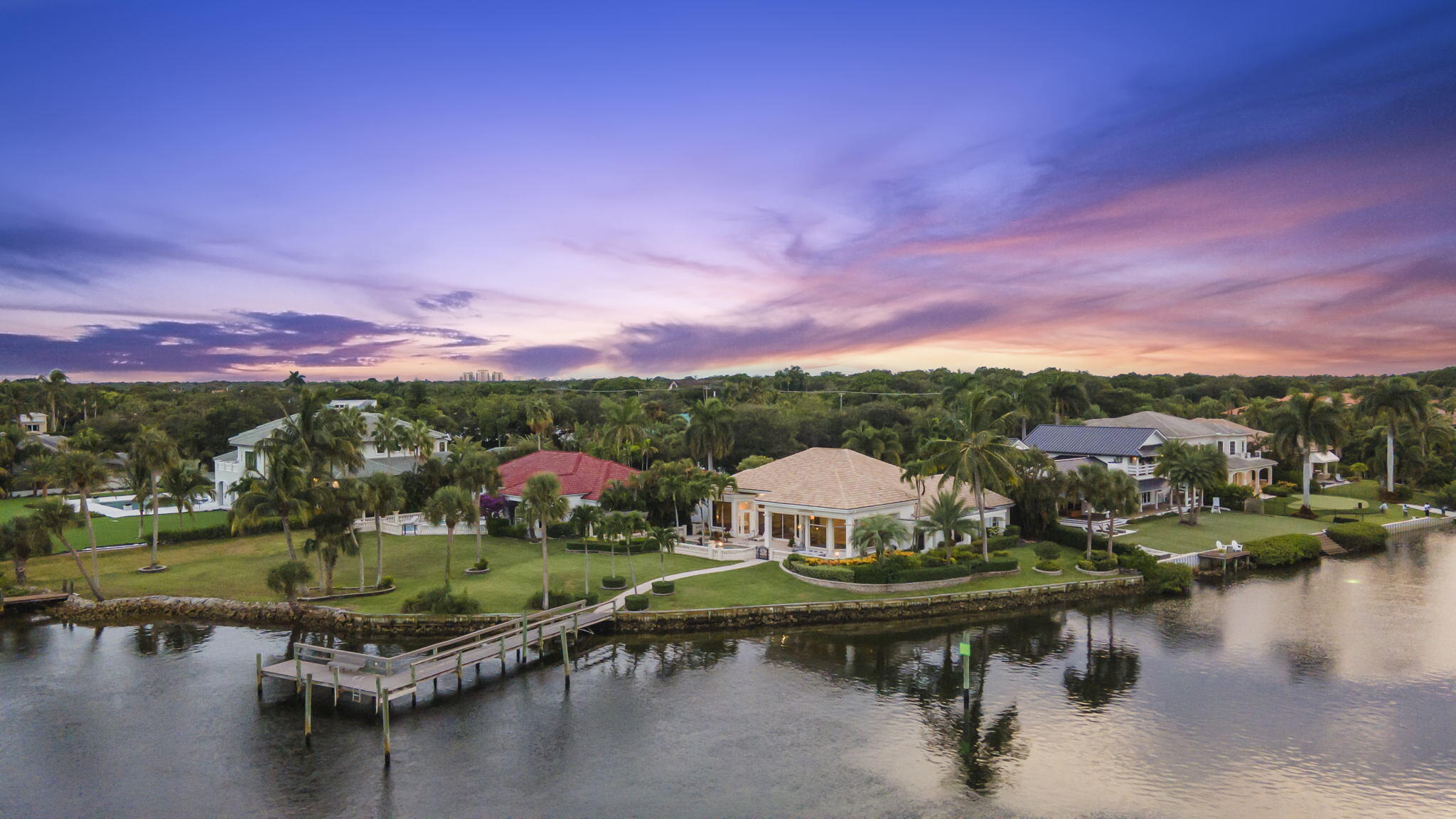 Exceptional waterfront property in a gated Palm Beach Gardens community with 230 feet of direct Intracoastal frontage and wide water views. This 3BR/3.5BA home offers approximately 3,300 SF of bright living space, spacious interiors, and a private pool overlooking the water. Existing dockage accommodates up to a 50-foot vessel, with a permit in process for a 72-foot dock with lifts. Proposed plans allow for expansion to accommodate up to a 100-foot vessel, offering rare long-term dockage potential. A unique opportunity to own substantial frontage with premier boating access in one of Palm Beach Gardens' most desirable locations.   All information pertaining to the property is deemed reliable, but not guaranteed. Information to be verified by the Buyer. Be advised that cameras may exist recording audio and video inside/outside the property, such as ring doorbells. Photos are digitally enhanced and could be altered, please verify.