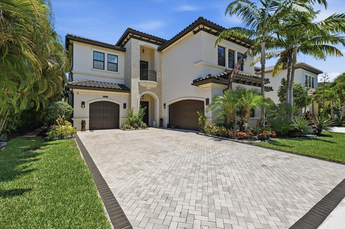 Experience elevated luxury living in this exceptional 5-bedroom, 5.1-bath waterfront estate, perfectly positioned to capture breathtaking long lake views. Showcasing the highly coveted Vizcaya model, this residence has been extensively upgraded with sophisticated finishes and timeless designer details throughout. The grand interior is defined by elegant porcelain flooring spanning the main living areas, while rich engineered hardwood flooring enhances the staircase, upper hallway, and expansive loft, creating warmth and refinement at every turn.  Designed to impress, the gourmet chef's kitchen features beautifully crafted shaker cabinetry with stacked upper cabinets, an upgraded enhancement package with illuminated upper and lower cabinetry, crown molding, pot and pan drawers, premium quartz countertops, and a striking designer glass backsplash. Thoughtfully designed for both luxurious everyday living and effortless entertaining, the home also features a built-in whole-home sound system, seamlessly integrating comfort and modern sophistication. Expansive living spaces and serene water views create an atmosphere of privacy, elegance, and tranquility. Residents enjoy access to an extraordinary collection of resort-inspired amenities, including a stunning clubhouse, state-of-the-art fitness center, indoor sports court, resort-style swimming pool, tennis and pickleball courts, and more—offering a lifestyle defined by luxury, recreation, and convenience.