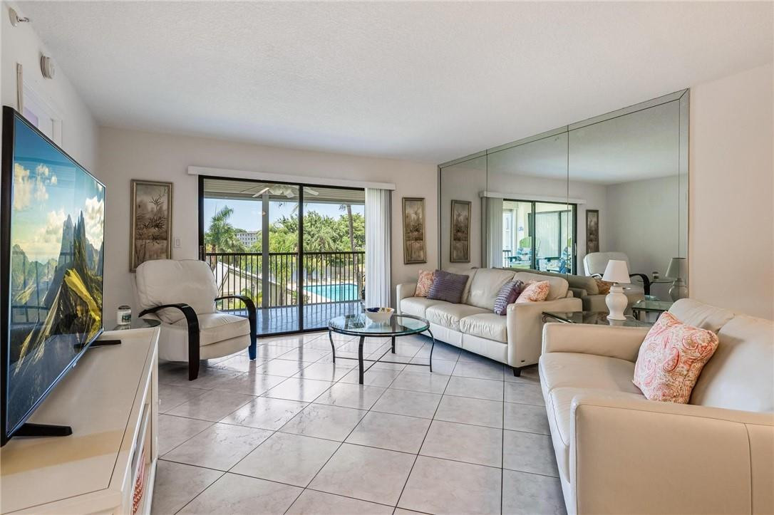 Pristine, Polished Perfection is Yours in this Meticulously Maintained, Waterfront End Unit...Corner Floor Plan has Brand-New Impact Windows All Around for Lots of Light & Sweeping 180-Degree Views. Open Kitchen & Spacious Great Room Offer a Contemporary Ambiance, while the Ample Screened Balcony--Overlooking the Glimmering Lake & Lush Pool Area--Makes the Perfect Spot Whether You're Relaxing or Entertaining. Ceramic Tile & Muted Paint Palette Throughout. Split Bedrooms Afford Greater Privacy. Welcoming Owner's Suite w/Home-Office Nook, Walk-In Closet, & Master Bath w/Large Step-In Shower. In-Unit Washer/Dryer. 1 Pet <20#. $5.3K SPECIAL ASSESSMENT PAID BY SELLER AT CLOSING! Heated Pool/Spa, BBQ, Tiki Bar, Jog Trails, Clubhouse, Pickleball/Tennis, Gym. Near Dining, Casino, Golf, Beach!