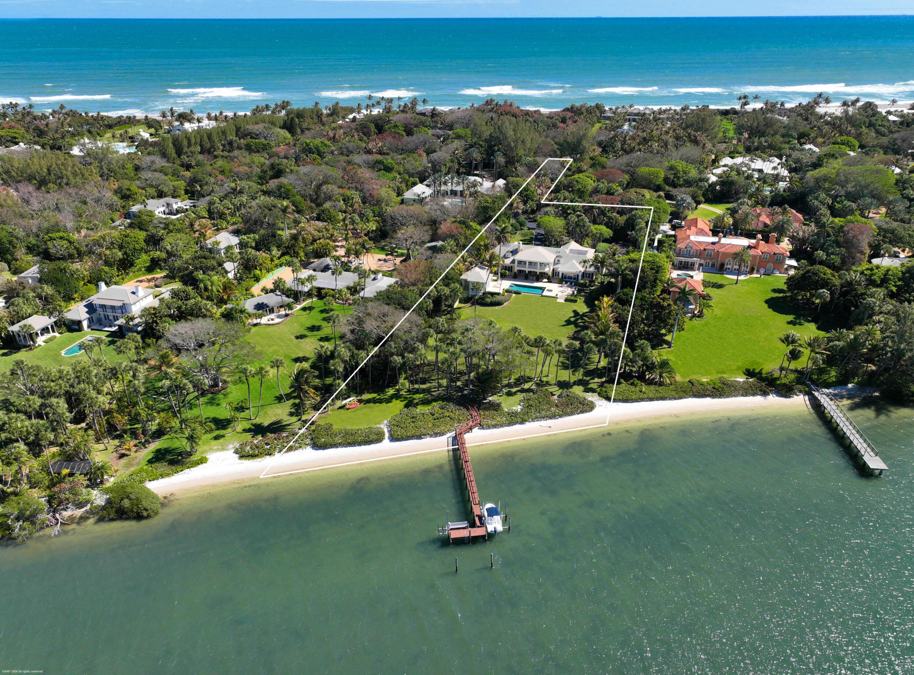 Welcome to 228 South Beach Road, a premier Intracoastal property on prestigious Jupiter Island. Set on 2.7 acres with sweeping water views across to a protected ''forever green'' preserve, this property offers exceptional privacy and scale. The elegant main residence is complemented by a separate guest house, creating a refined compound ideal for multi generation living or guests. Expansive outdoor living areas capture the waterfront setting, anchored by a large resort-style pool and generous lawns with room for a tennis court. A substantial private dock with two lifts provides direct Intracoastal access. A rare opportunity to secure prime acreage, dockage, and enduring views on Jupiter Island. Ideally situated with quick access off the Island to the areas most renowned private golf clubs.