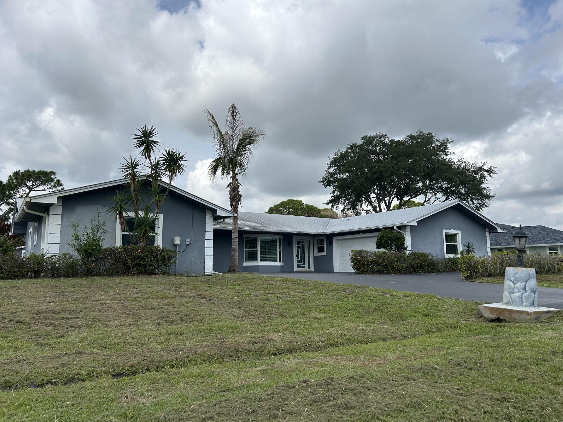 Discover this spacious CBS construction main home featuring 4 bedrooms, 3 bathrooms, plus a separate mother-in-law suite — bringing the total to 5 bedrooms and 4 baths. This well-built home offers a huge family room, inside laundry, newer metal roof, impact windows, and tile flooring throughout the main living areas. Additional features include a 2-car garage, circular driveway, large lot with storage shed, and a screened pool with patio — perfect for entertaining and outdoor living. Sold as-is with right to inspect. All room sizes are approximate.