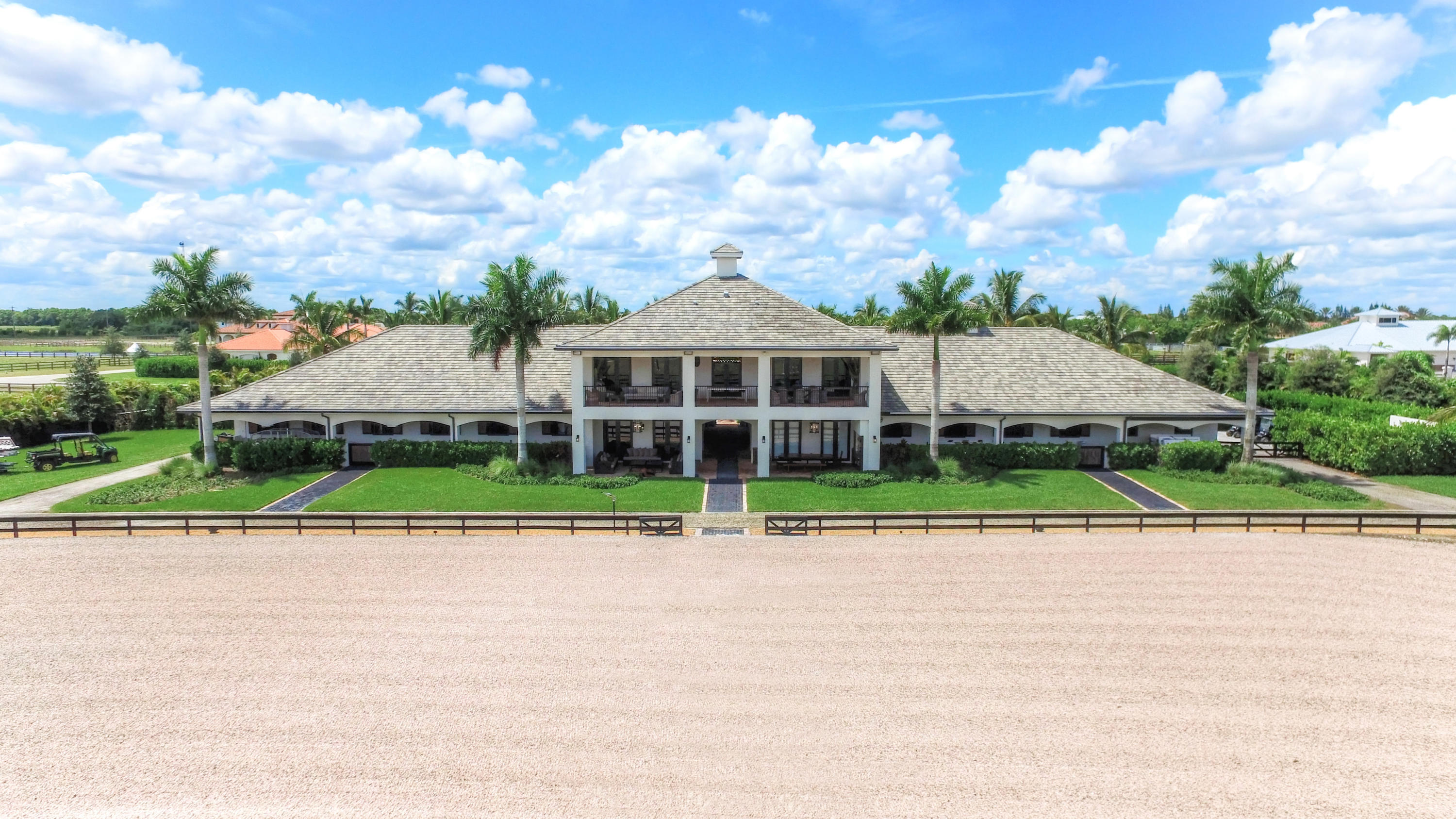This spectacular 20-stall barn on 5.62 acres in the sought after Grand Prix Village has it all! Complete with top of the line equipment such as an Equi Spa, water treadmill, 4 wash racks, 2 tack rooms, Diptera fly system, air-conditioned feed room, laundry room, Crestron audio system throughout the property, security cameras, alarm system and enough jumps to build your own Grand Prix course!

For the owner there is a luxurious 2 bedroom/2 bath apartment on the second floor with huge gourmet kitchen and breakfast bar, living room, dining area, laundry room, wide plank wood floors, and large private balcony overlooking the Grand Prix field with both dining and living area including a pool table.

Downstairs there is a lounge area with a dining area that seats 10, Sony flat screen TV, and kitchenette with Sub-Zero fridge, microwave and dishwasher.  Perfect for lunch breaks or after hours events. The outdoor patio on the lower level features a Brazilian BBQ, dining area with seating for 12 and living area all furnished to the highest quality. To complete the amenities is a beautifully furnished office that comes complete with Mac desktop computer and printer.
This remarkable property is a must see for the discerning equestrian family.