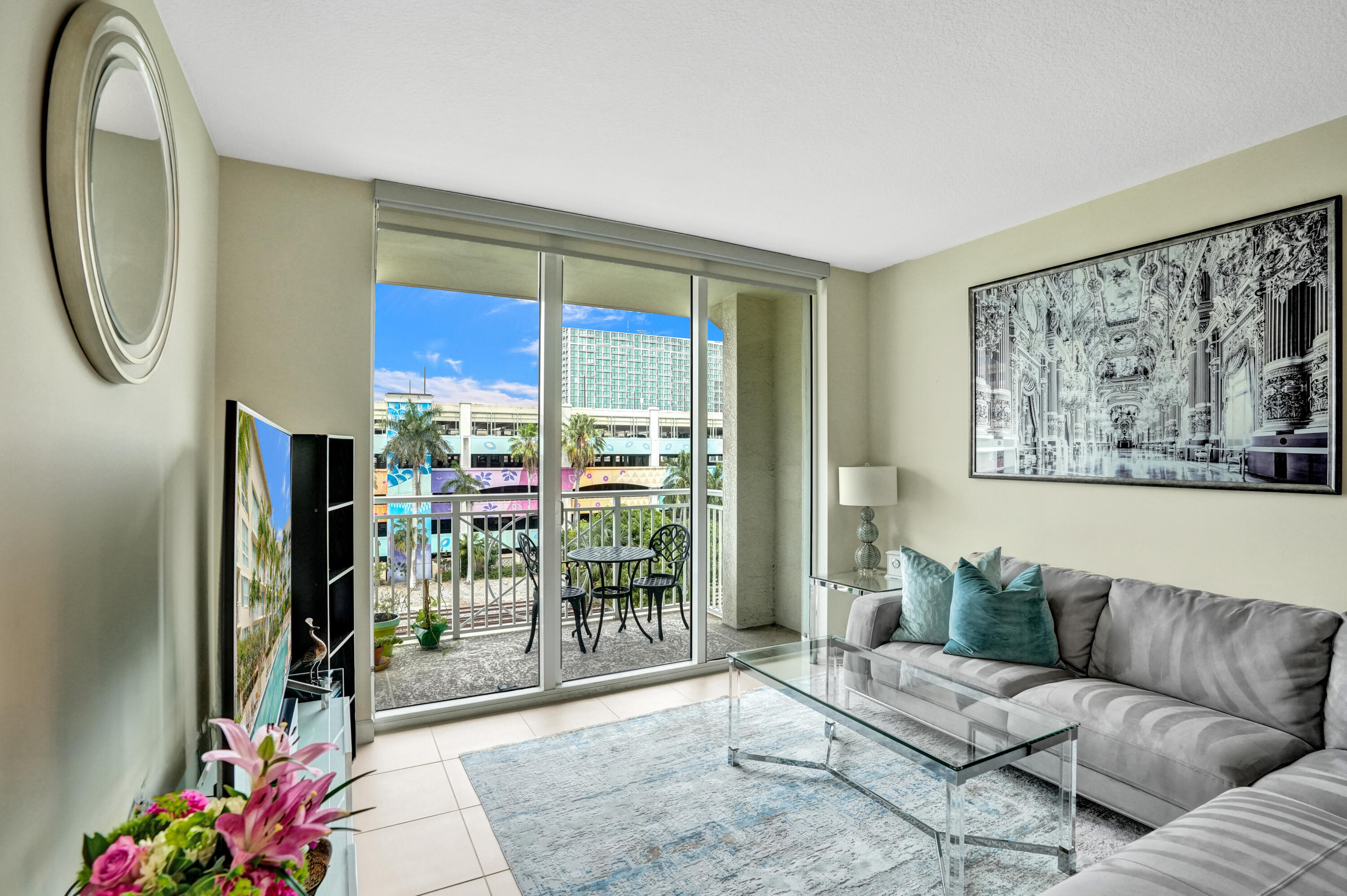 This sophisticated 2BR/2BA residence at City Palms offers refined living in the vibrant heart of West Palm Beach. Positioned on the 4th floor, this light-filled condo features a thoughtfully designed split-bedroom layout and seamless open-concept living. The contemporary kitchen flows effortlessly into spacious living and dining areas, creating a modern, inviting ambiance. The primary suite boasts dual vanities, a soaking tub, glass-enclosed shower, and generous walk-in closet space. Impact glass, a private balcony with city views, same-level garage parking, in-unit washer/dryer, and 24-hour front desk/security enhance comfort. Enjoy a 70-foot pool, spa, fitness center, sauna, lounge, and valet services. Just one block from City Place and moments to the waterfront, dining, and shopping.