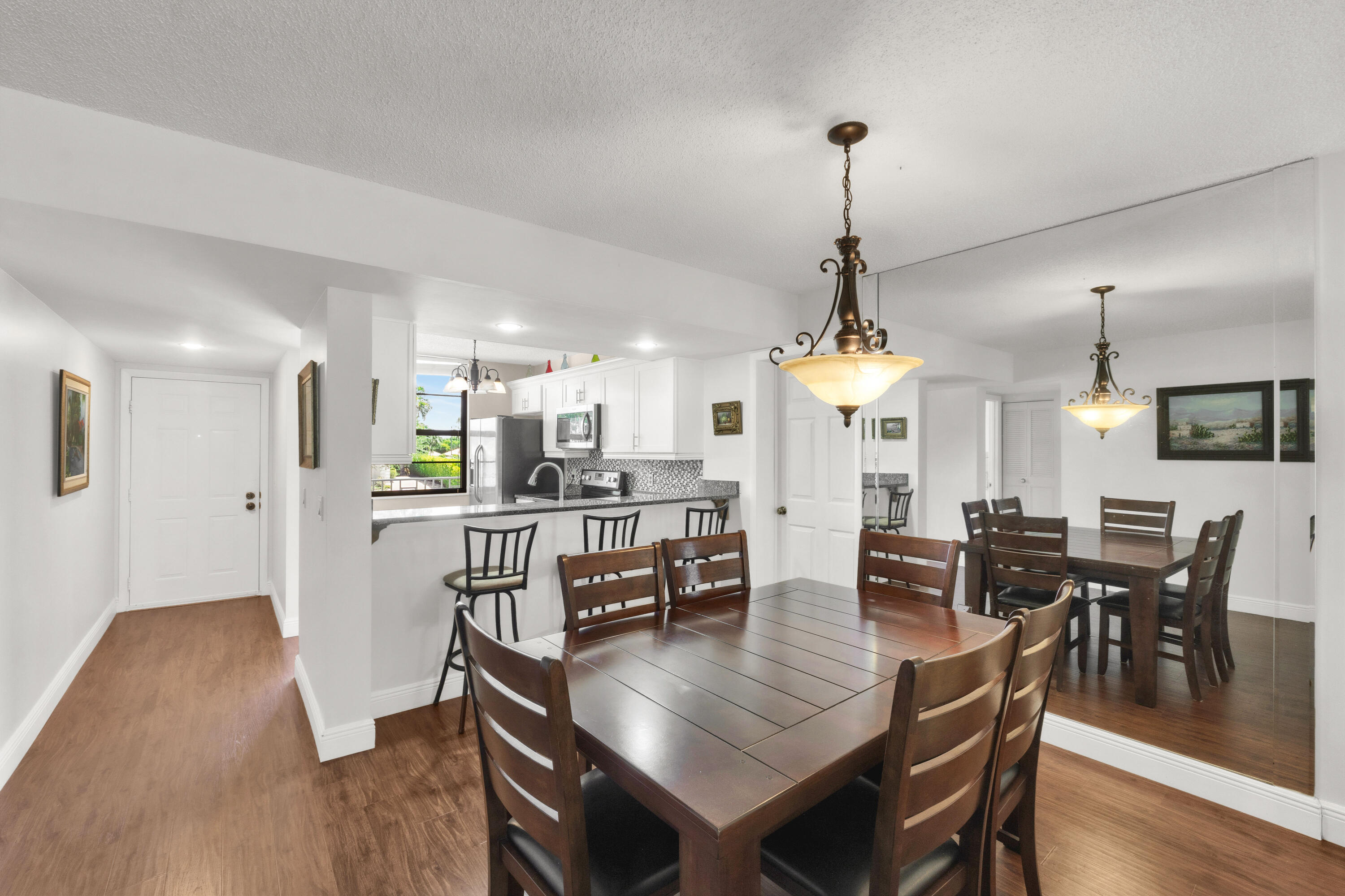 Welcome to Whitehall, a gated, all-ages and pet-friendly community ideally located just minutes from Downtown West Palm Beach, CityPlace, Palm Beach Outlets, beaches, airports, and major highways. This spacious southwest-facing residence offers tranquil pool views and features a tastefully renovated kitchen, engineered wood flooring, brand new impact windows, and fresh interior paint. A separate laundry room with newer appliances includes a versatile additional space ideal for a small office, extra storage, or flex use to suit your needs. Roof replacement is planned, with all assessments to be paid by Seller. Residents enjoy a pool, clubhouse, and on-site property manager. Available furnished and turnkey, this inviting home offers the ideal blend of tranquility, safety and convenience.
